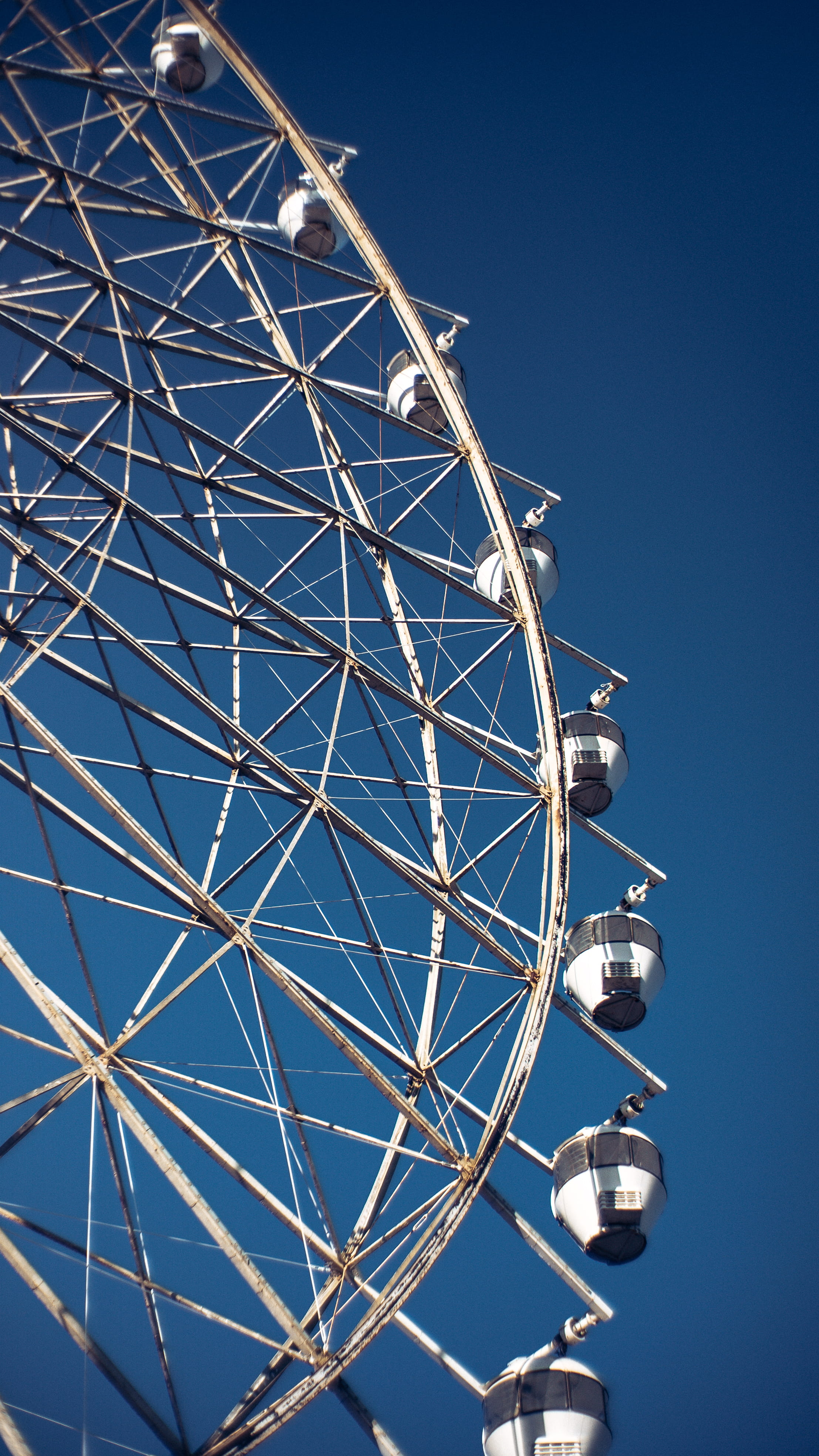low angle view, ferris wheel, carnival, blue, day, outdoors, spoke, nature, clear sky, tagaytay, fairground, plywood, adventure, crowd, no people, amusement park, Phone HD Wallpaper