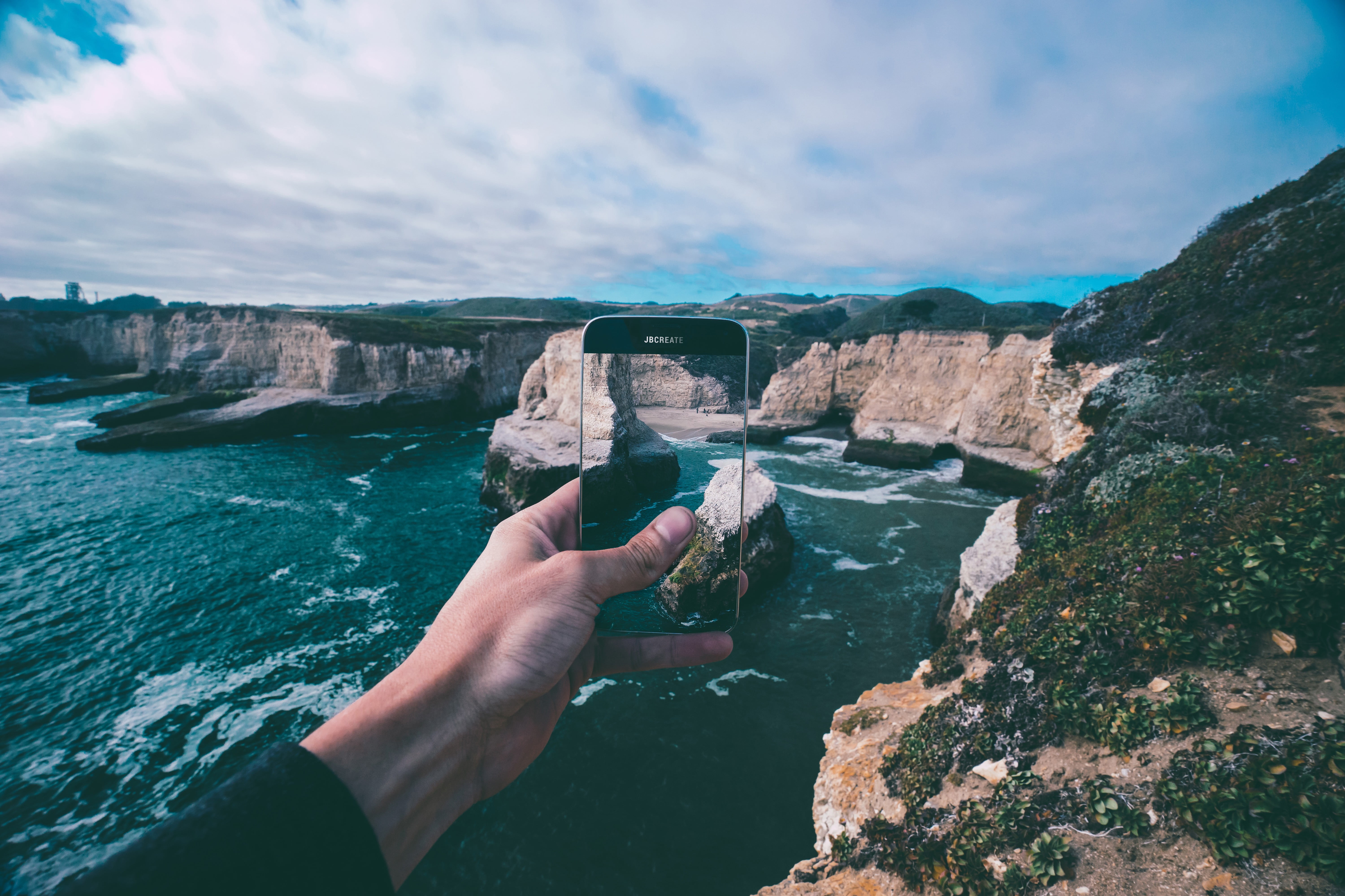 rock formation, day, hand, outdoors, cliff, human hand, 5K, android, one person, phone, human body part, solid, sea, landscape, black, personal perspective, HD Wallpaper
