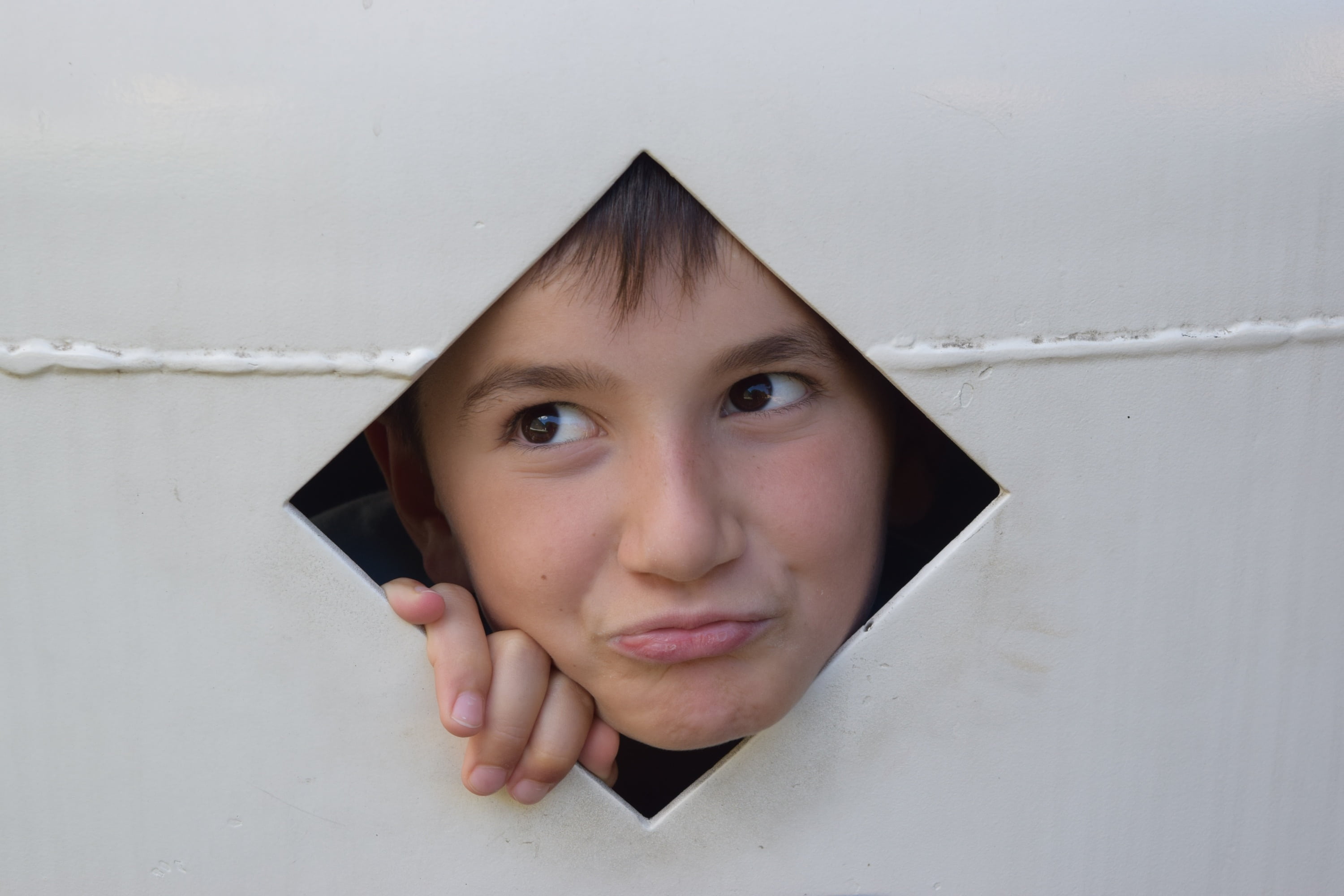 front view, contemplation, offspring, one person, human body part, looking at camera, portrait, childhood, fun, 2K, curiosity, hole, playground, headshot, HD Wallpaper