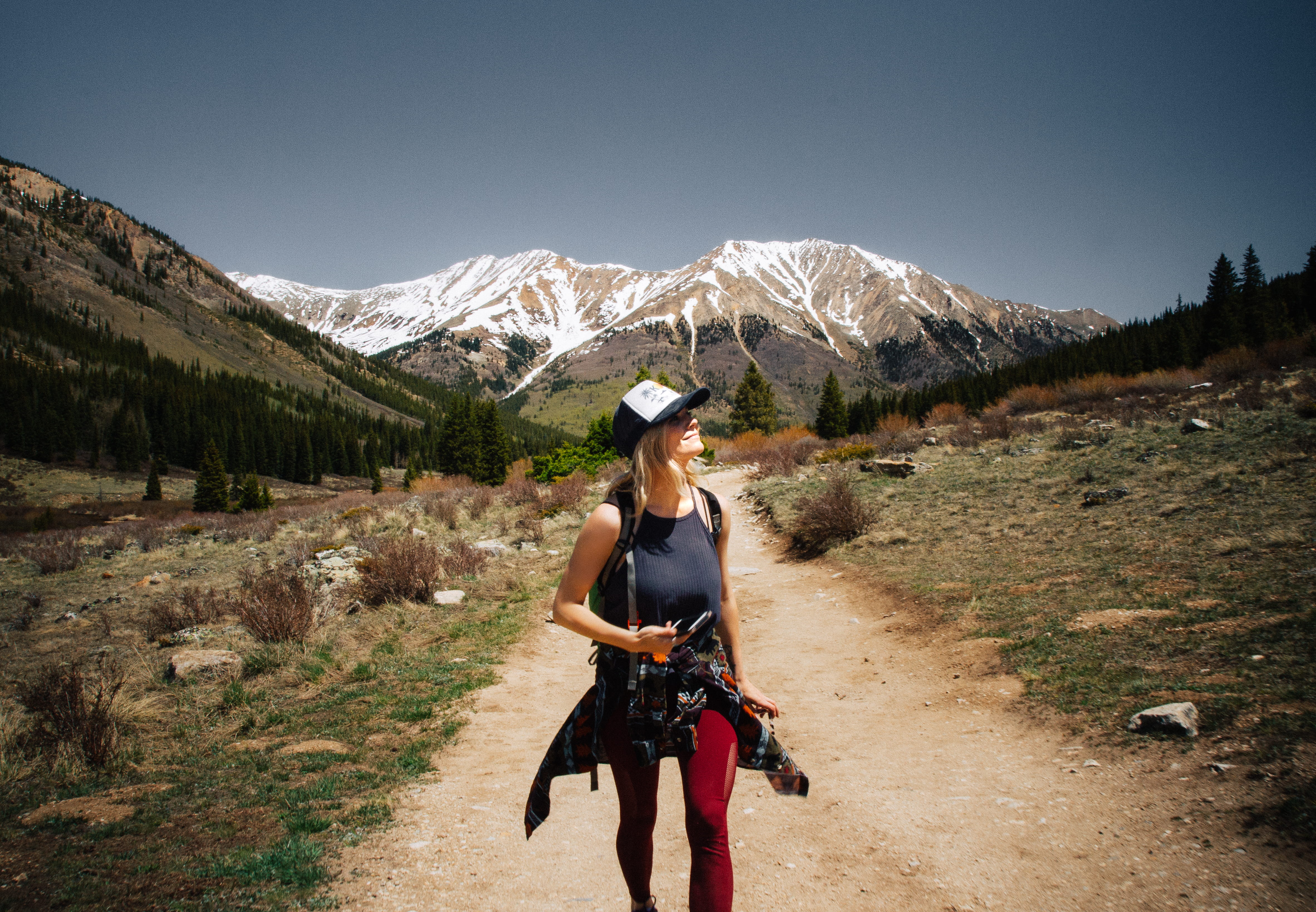 sunlight, scenics - nature, clothing, environment, woman, track, holding, snow, standing, women, road, exploration, raod, adult, brown, grass, path, hat, HD Wallpaper