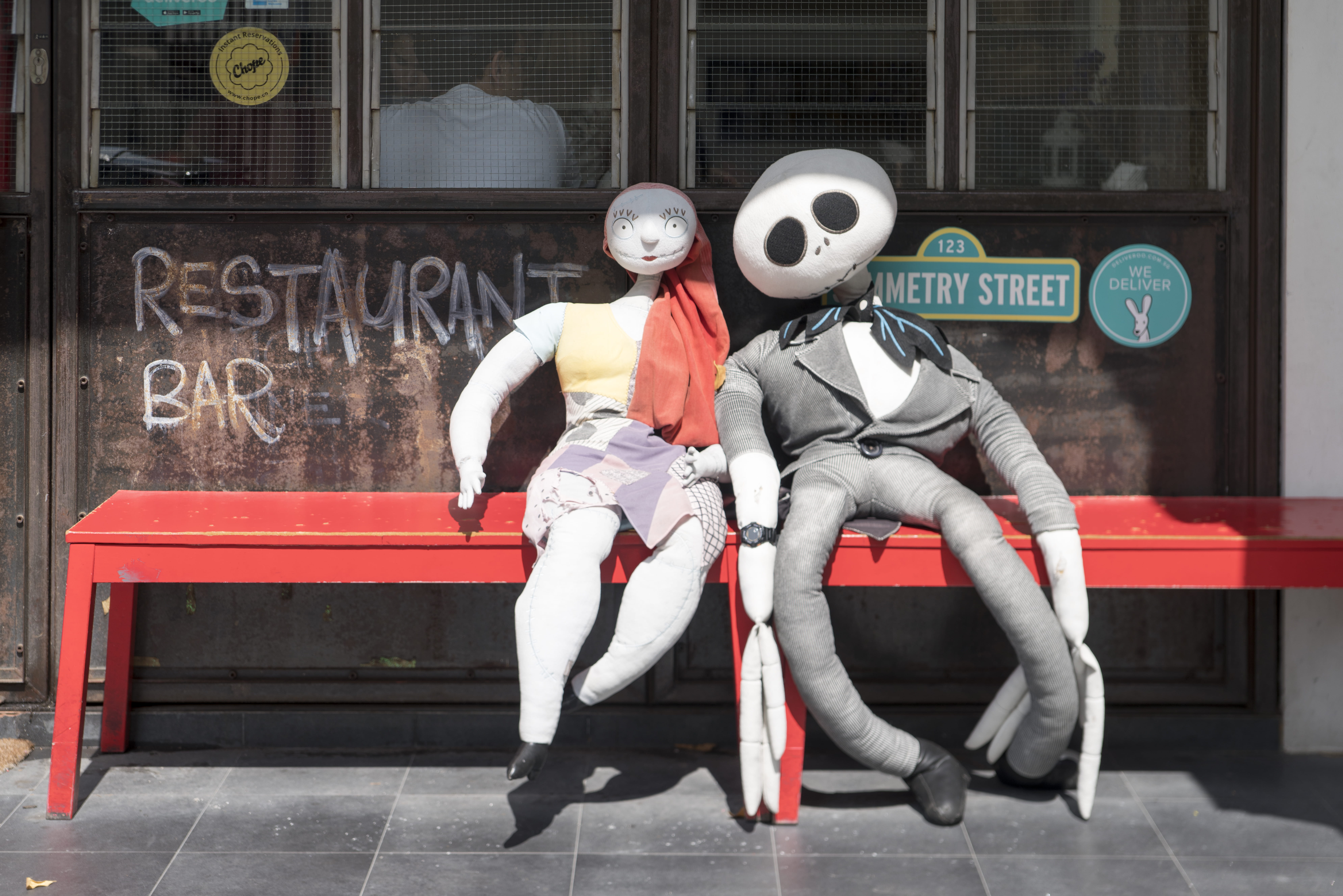 sitting, full length, lifestyles, jalan kubor, shop front, dolls, men, leisure activity, sony a7rii, representation, outdoors, cafe, day, people, helmet, HD Wallpaper