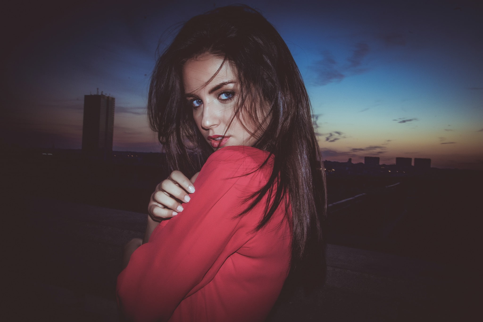 long hair, red clothing, blue eyes, women, portrait, women outdoors, cityscape, 1080P, model, face, sky, dark, 500px, Aurela Skandaj, HD Wallpaper