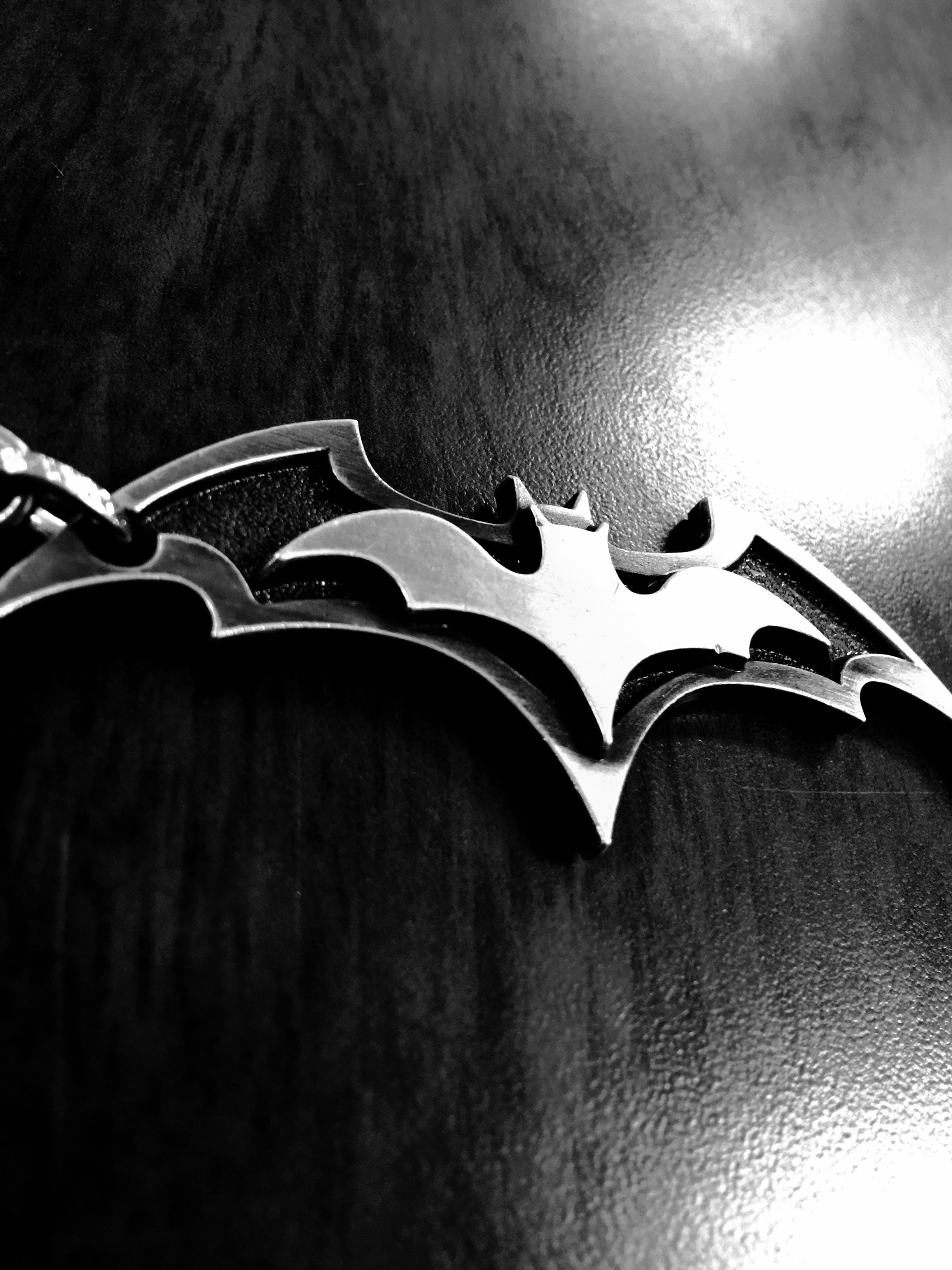 arts culture and entertainment, no people, table, close-up, book, studio shot, focus on foreground, vignette, Batman logo, simplicity, DC Comics, indoors, Phone HD Wallpaper