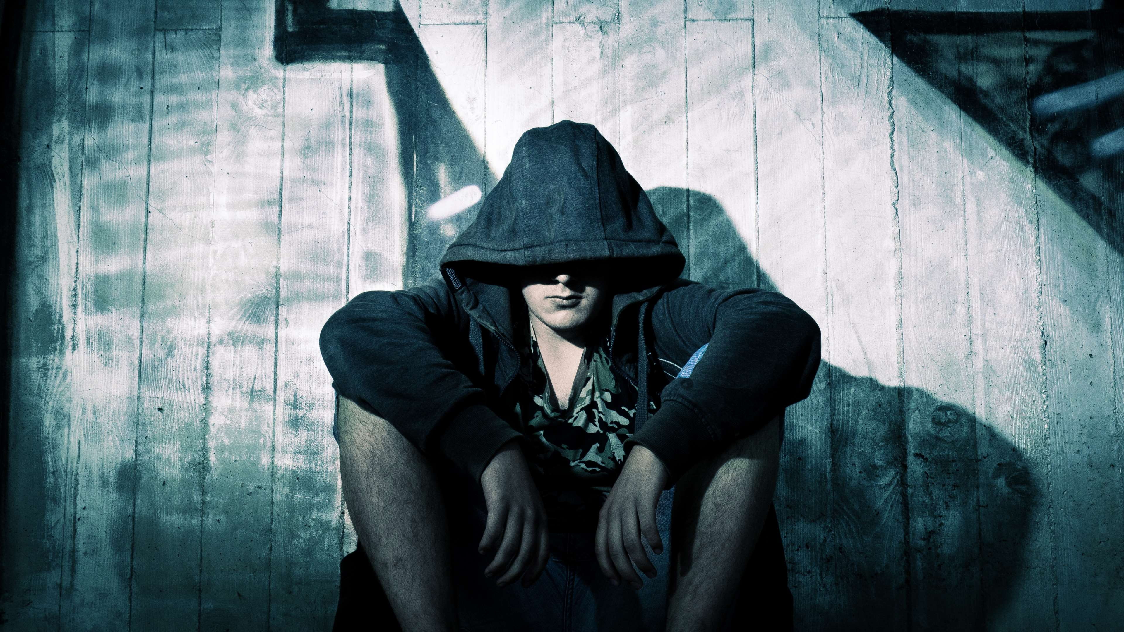 hooded shirt, shadow, real people, sitting, emotion, hood - clothing, dark, wooden, one person, three quarter length, fashion, jacket, wear, young adult, HD Wallpaper