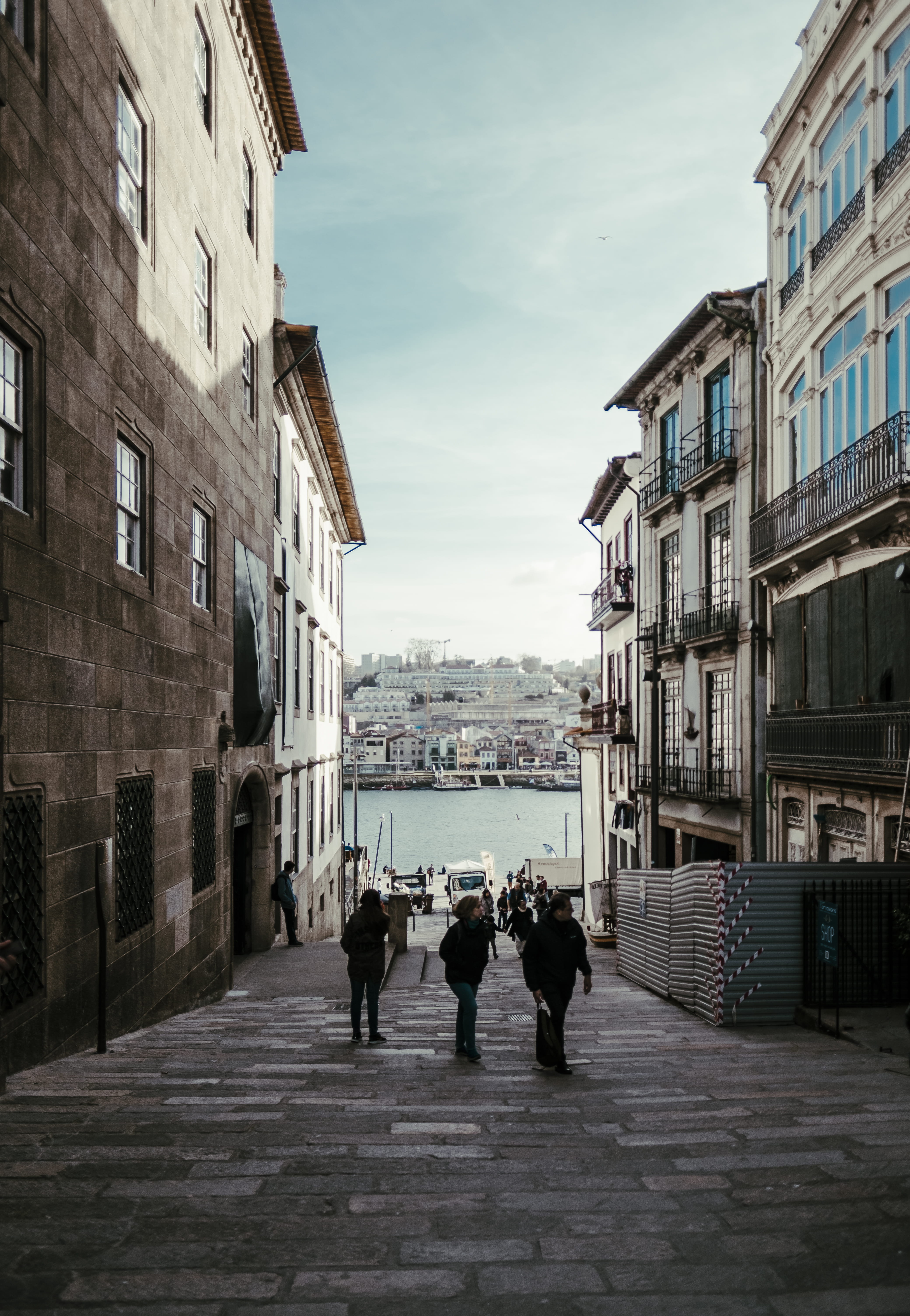 street, human, near, pedestrian, group of people, built structure, waterfront, real people, person, cobblestone, sky, boardwalk, outdoors, water, direction, Phone HD Wallpaper