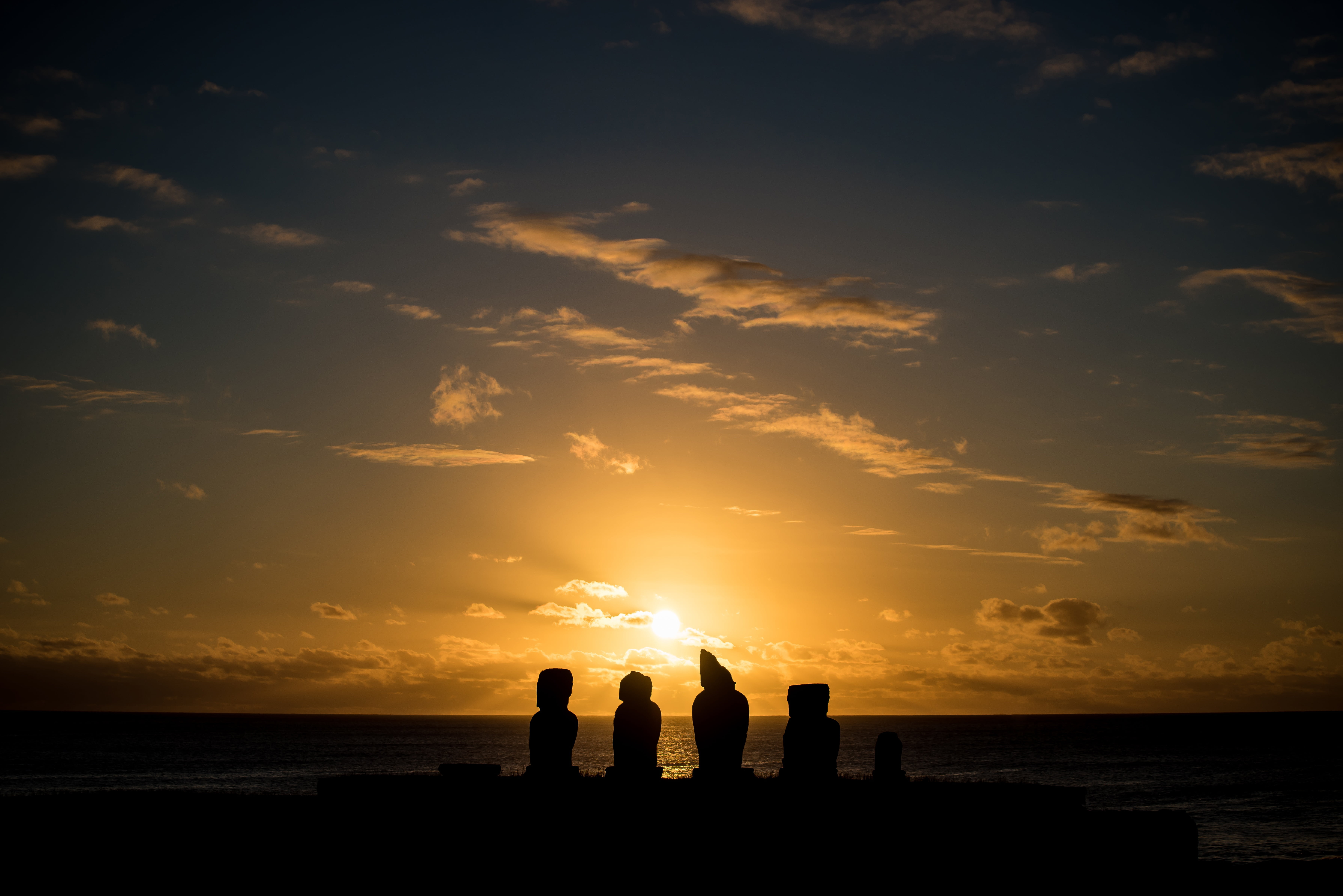 backlight, polynesia, sunset, two people, easter, sea, beach, silhouette, horizon, sun, moai, cliff, outdoors, tranquility, old, 5K, clouds, ocean, horizon over water, HD Wallpaper