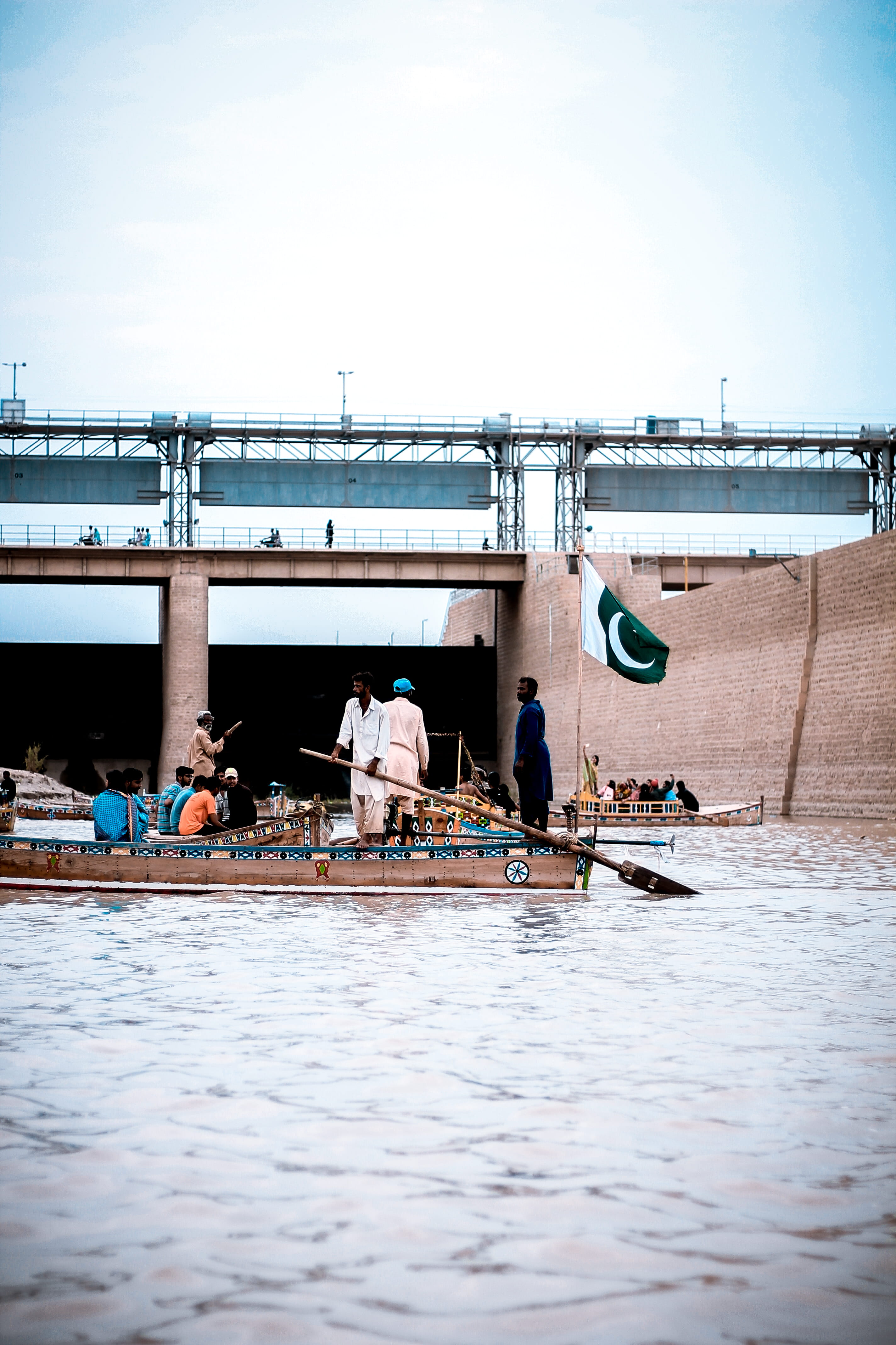 built structure, outdoors, water, transportation system, men, architecture, watercraft, working, bridge, jamshoro river, pakistan, flag, waterfront, day, Phone HD Wallpaper