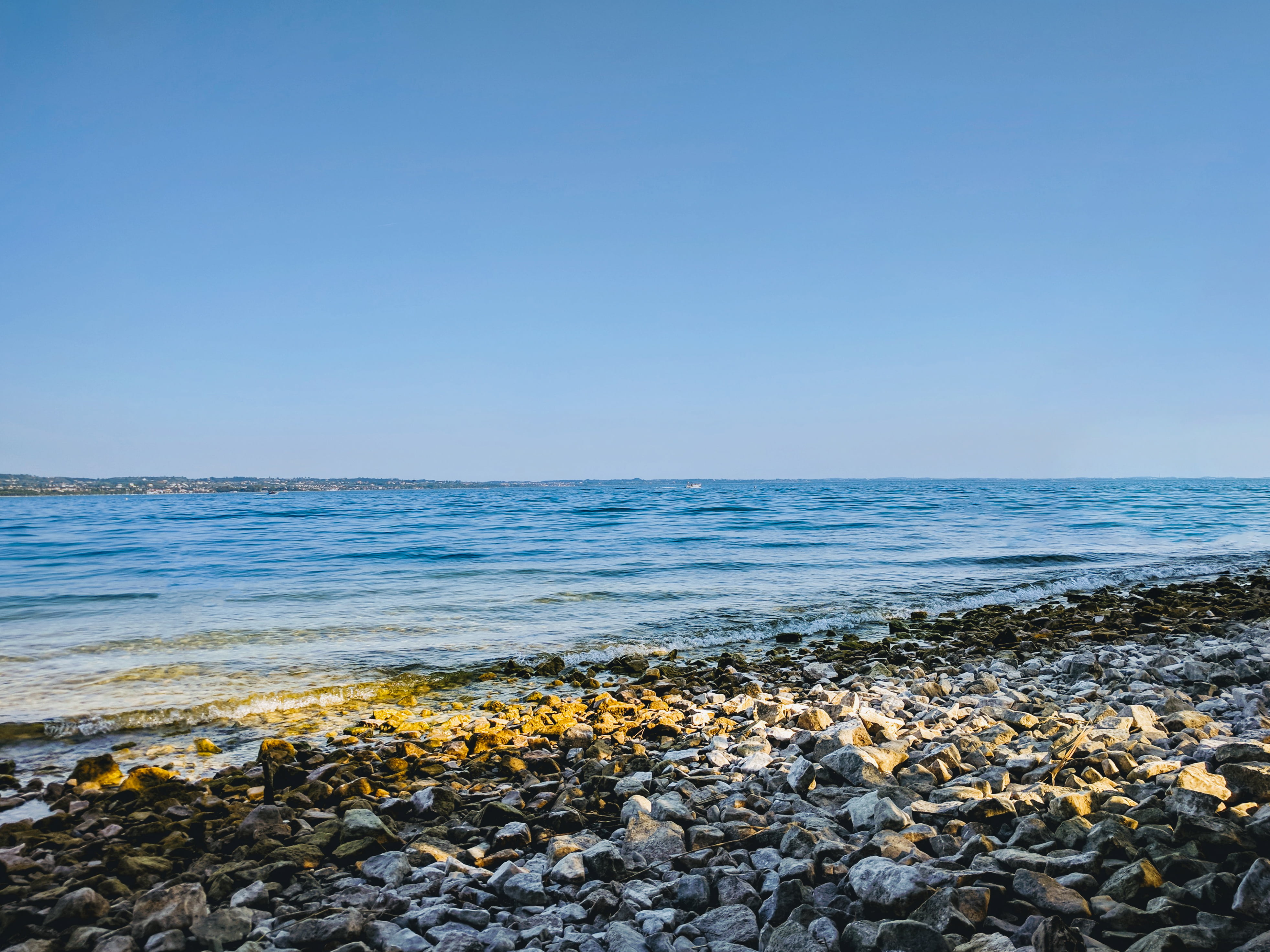 solid, copy space, day, nature, rock - object, beach, blue, pebble, tranquility, clear sky, horizon over water, horizon, brown, land, rocky, water, 4K, HD Wallpaper
