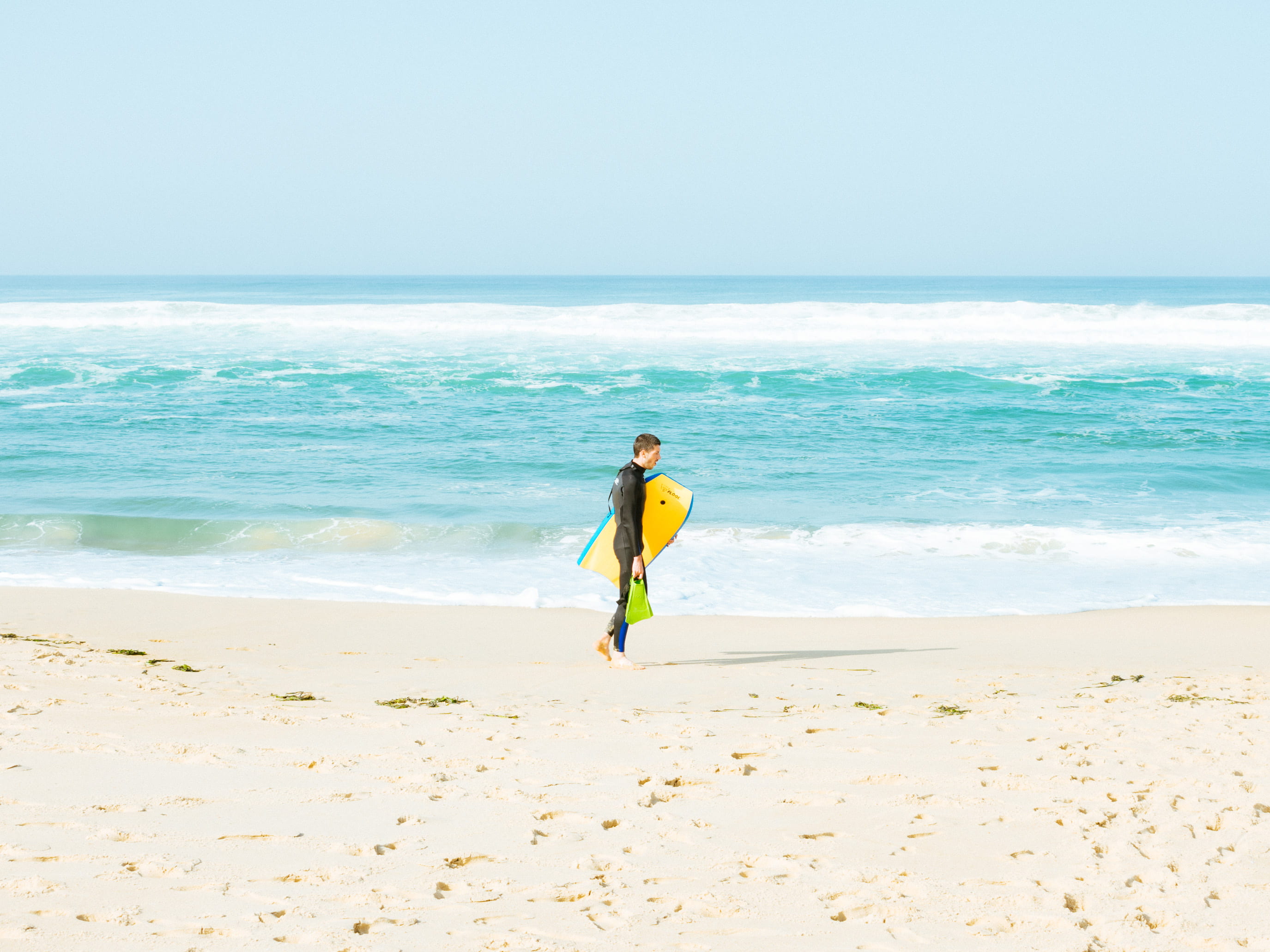 bodyboard, real people, carrying, day, holding, leisure activity, beach, yellow, horizon, seashore, holiday, motion, sky, one person, surfboard, beauty in nature, HD Wallpaper