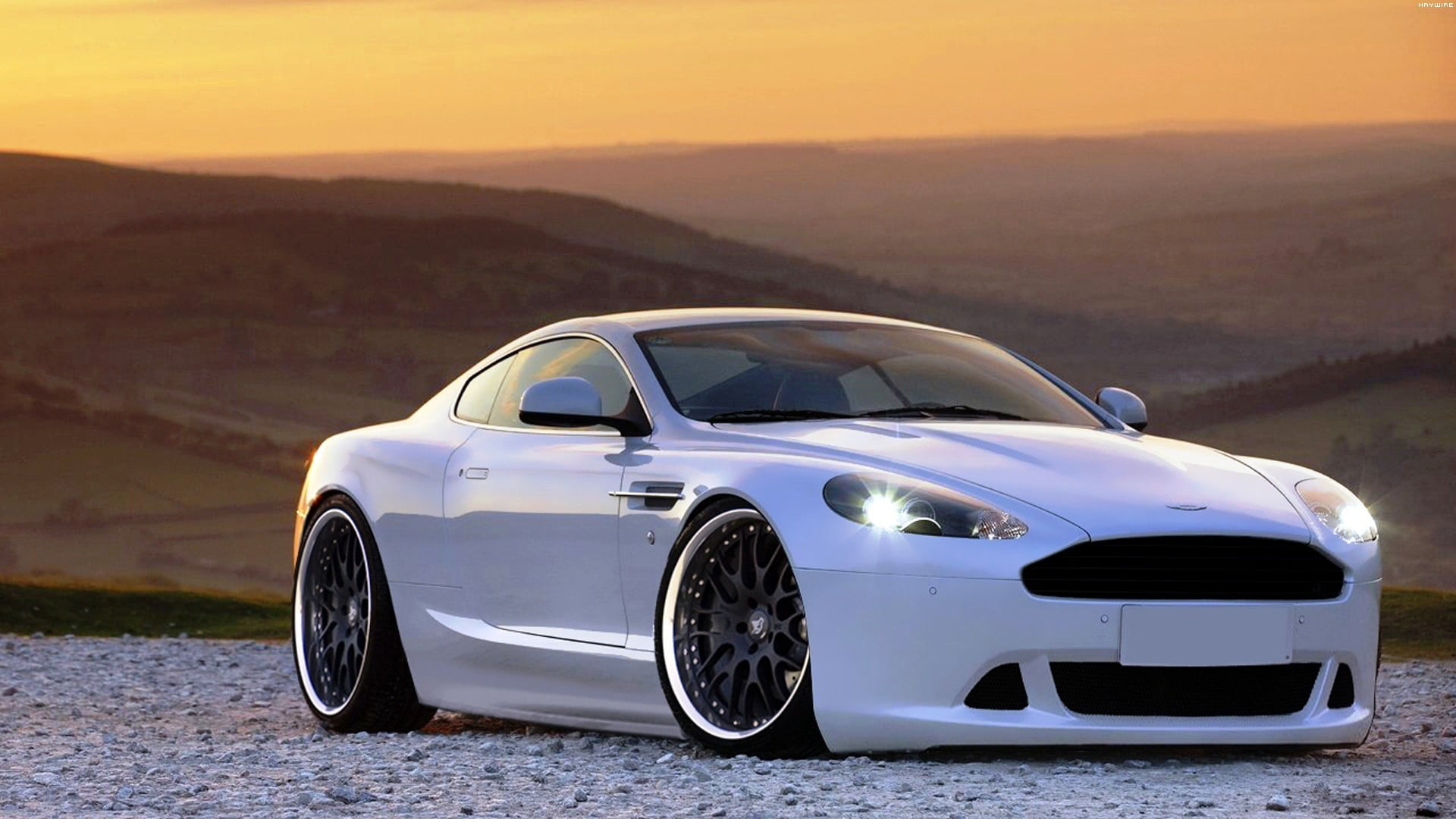 white, Aston Martin, mountain, travel, environment, vehicle, mode of transportation, 1080P, sky, outdoors, landscape, coupe, wheel, transportation, road trip, HD Wallpaper