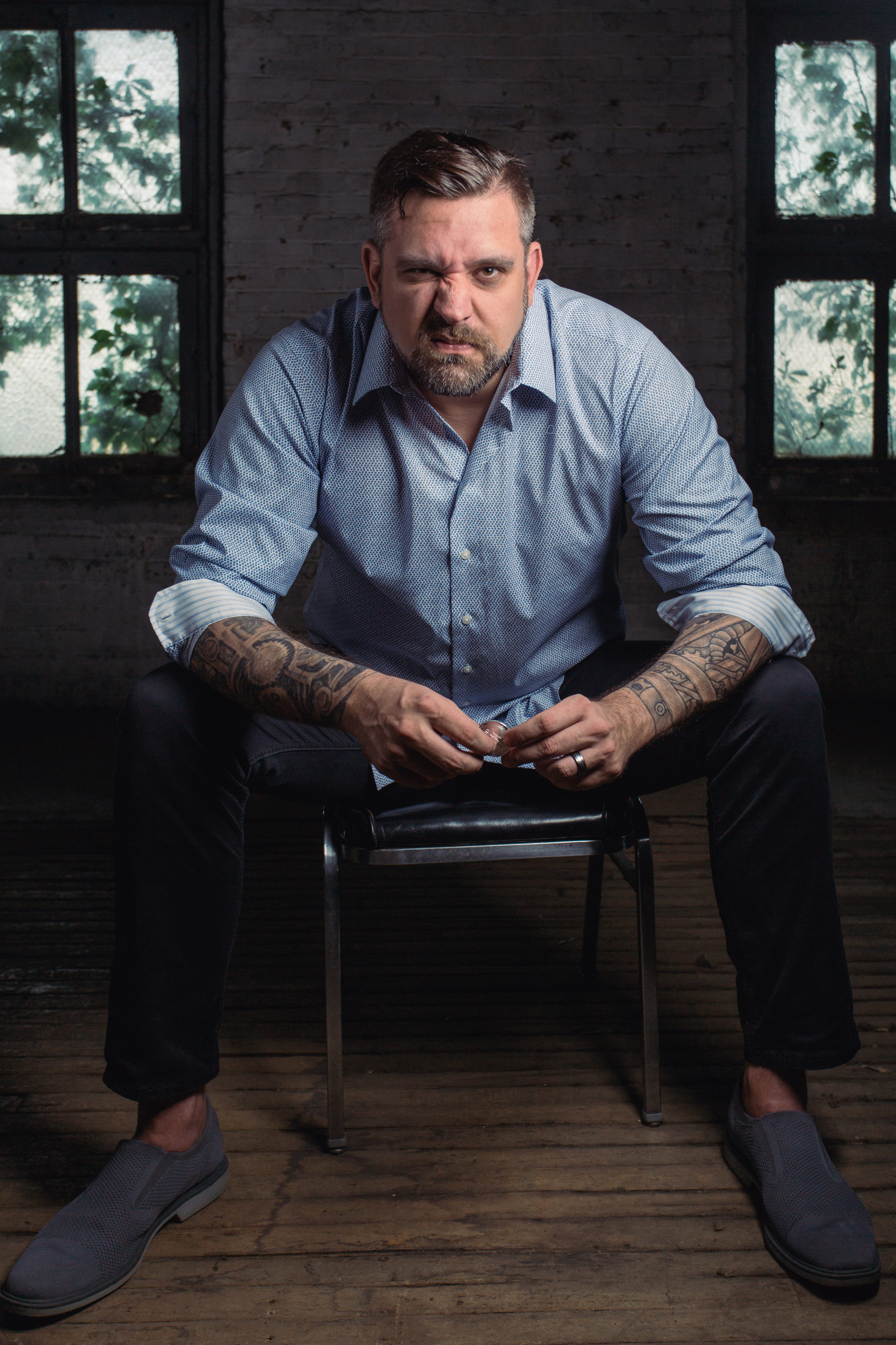 tattoos, sitting, men, indoors, sit, wear, front view, facial hair, casual clothing, adult, full length, blue shirt, 5K, beard, one person, angry, room, Phone HD Wallpaper