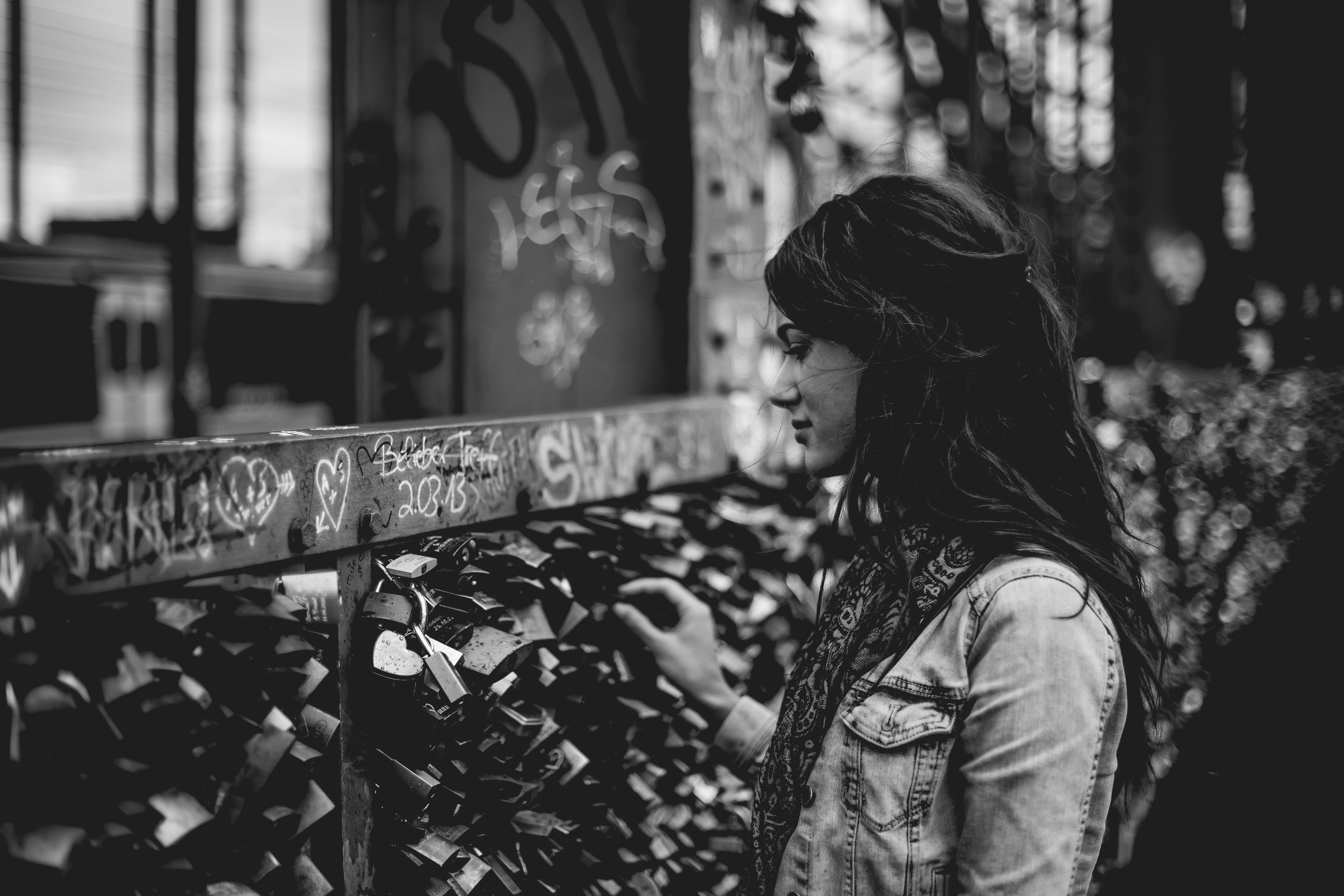 white, woman, holding, touch, grayscale, lock, hairstyle, 5K, day, side view, fence, brown, standing, one person, urban, black, innocence, waist up, sitting, HD Wallpaper