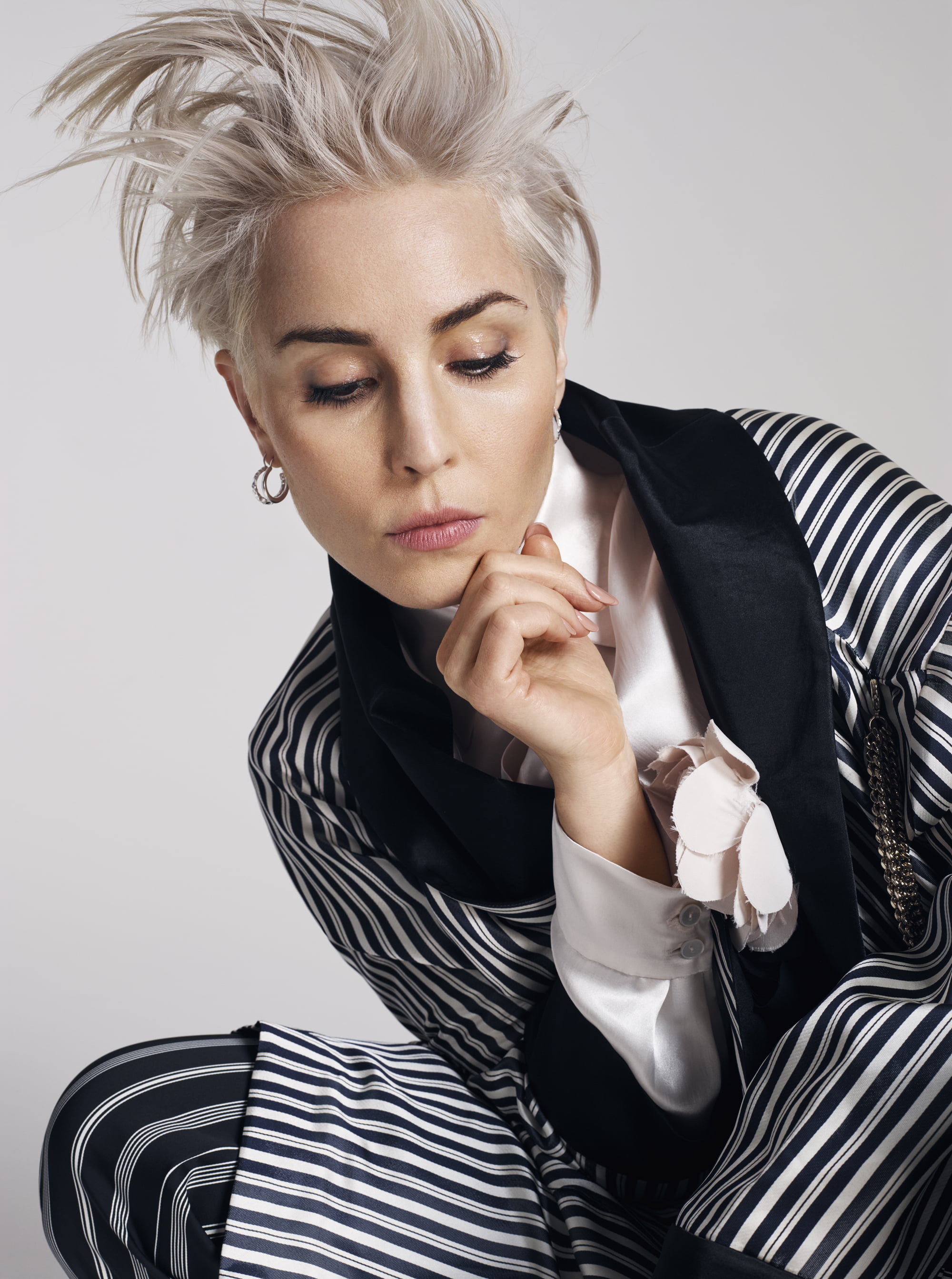 body part, fashion, striped, blonde, brown eyes, modern, human face, contemplation, sitting, females, hair, beautiful people, Noomi Rapace, women, one person, Phone HD Wallpaper