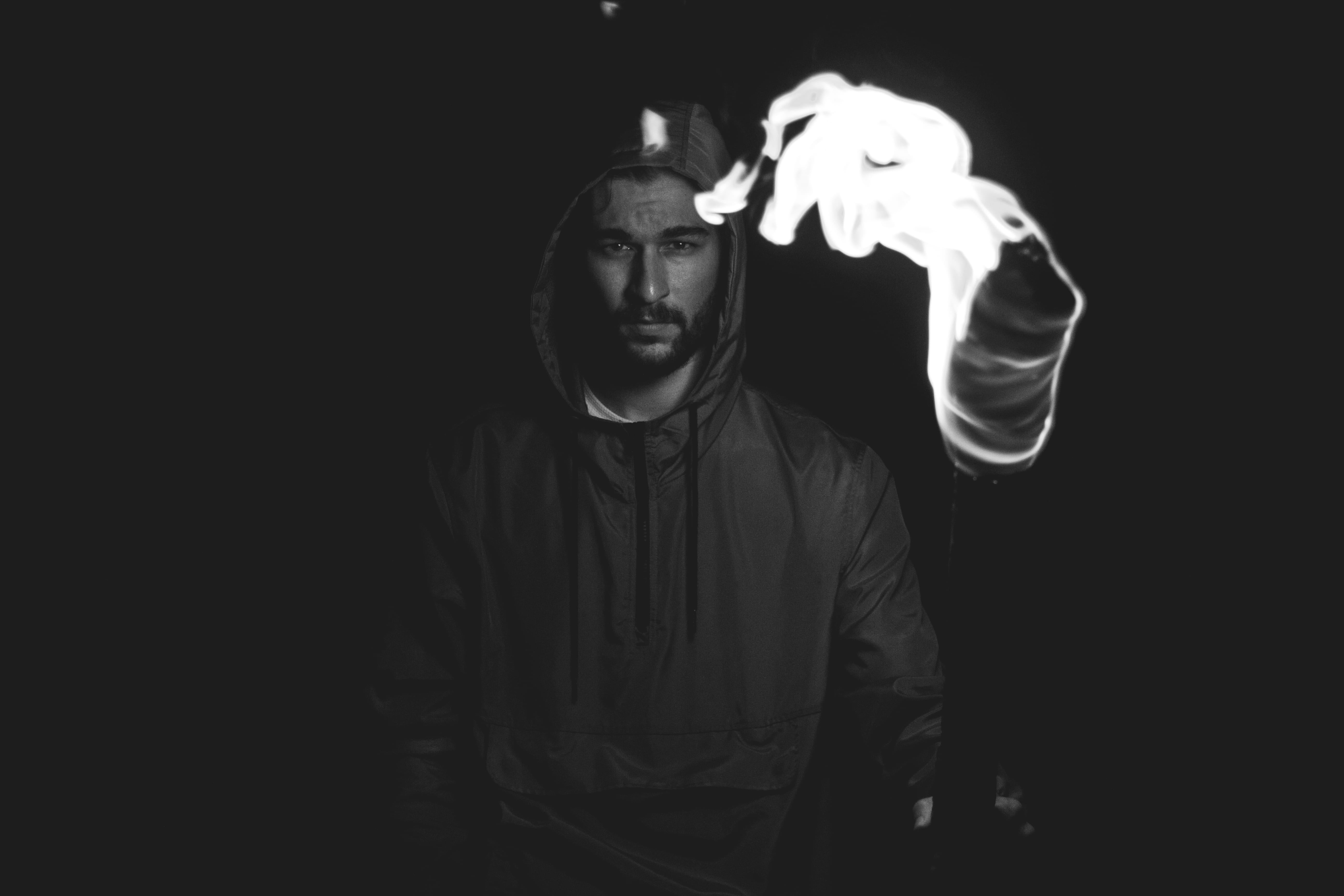 wildlife, adult, black background, holding, beard, men, bearded, one person, night, man, illuminated, indoors, dark, copy space, looking at camera, hoodie, HD Wallpaper