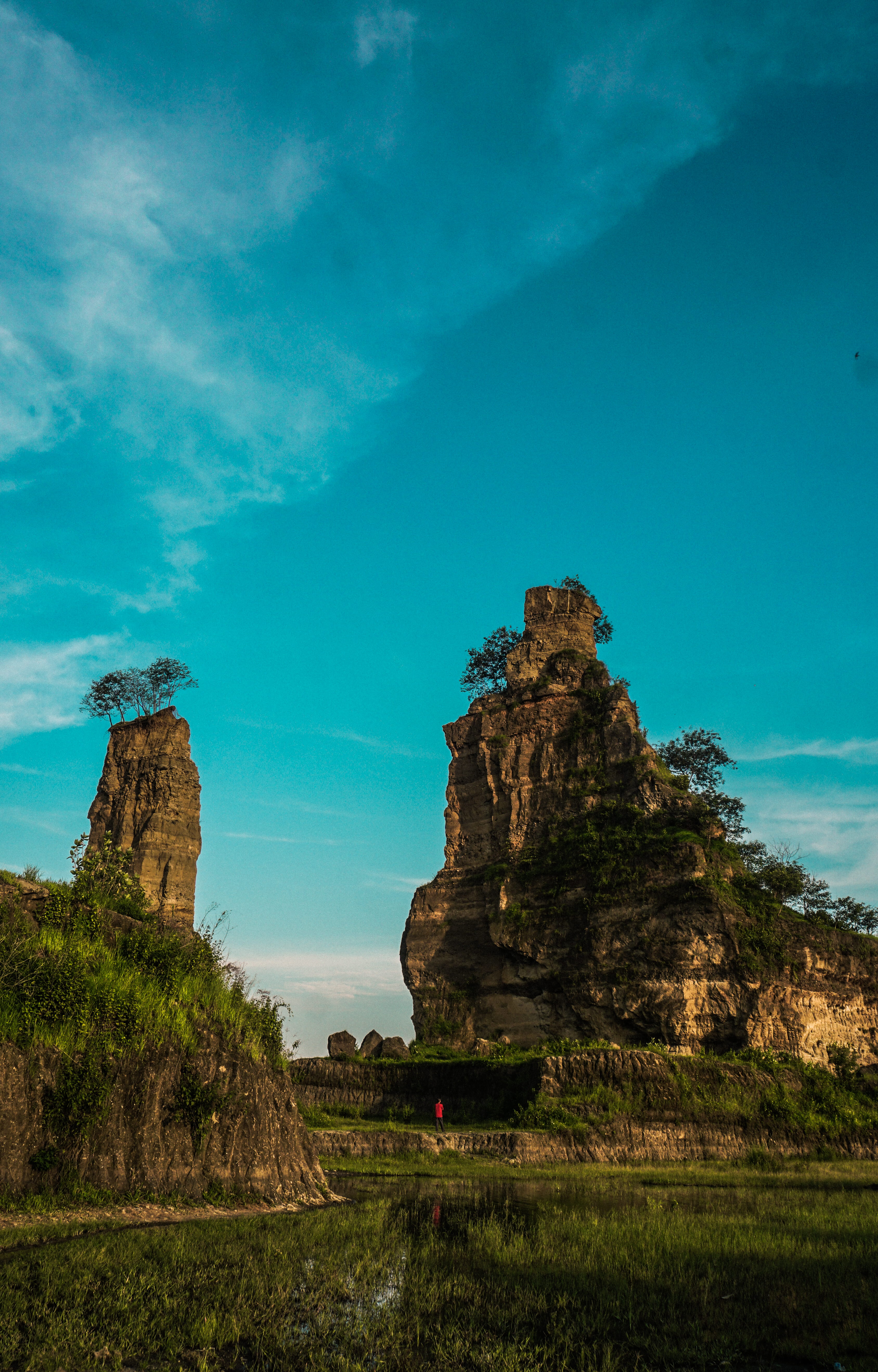 central java, tranquil scene, beside, daytime, blue, land, eroded, no people, landscape, brown canyon, grass, tourist, rock formation, tranquility, formation, Phone HD Wallpaper