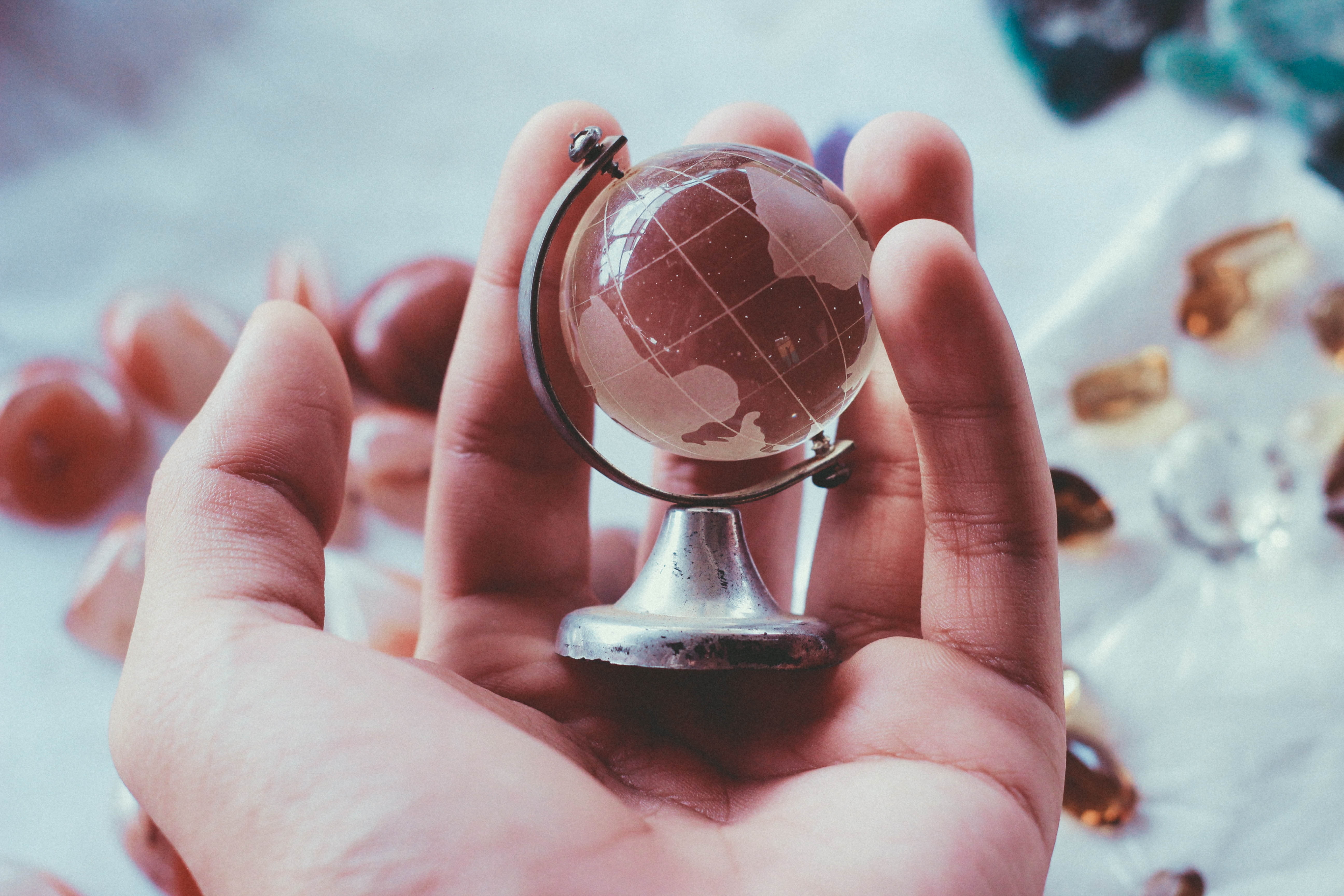 real people, human finger, sphere, indoors, finger, body part, holding, day, desk, close-up, souvenir, one person, globe, 5K, hand, unrecognizable person, HD Wallpaper