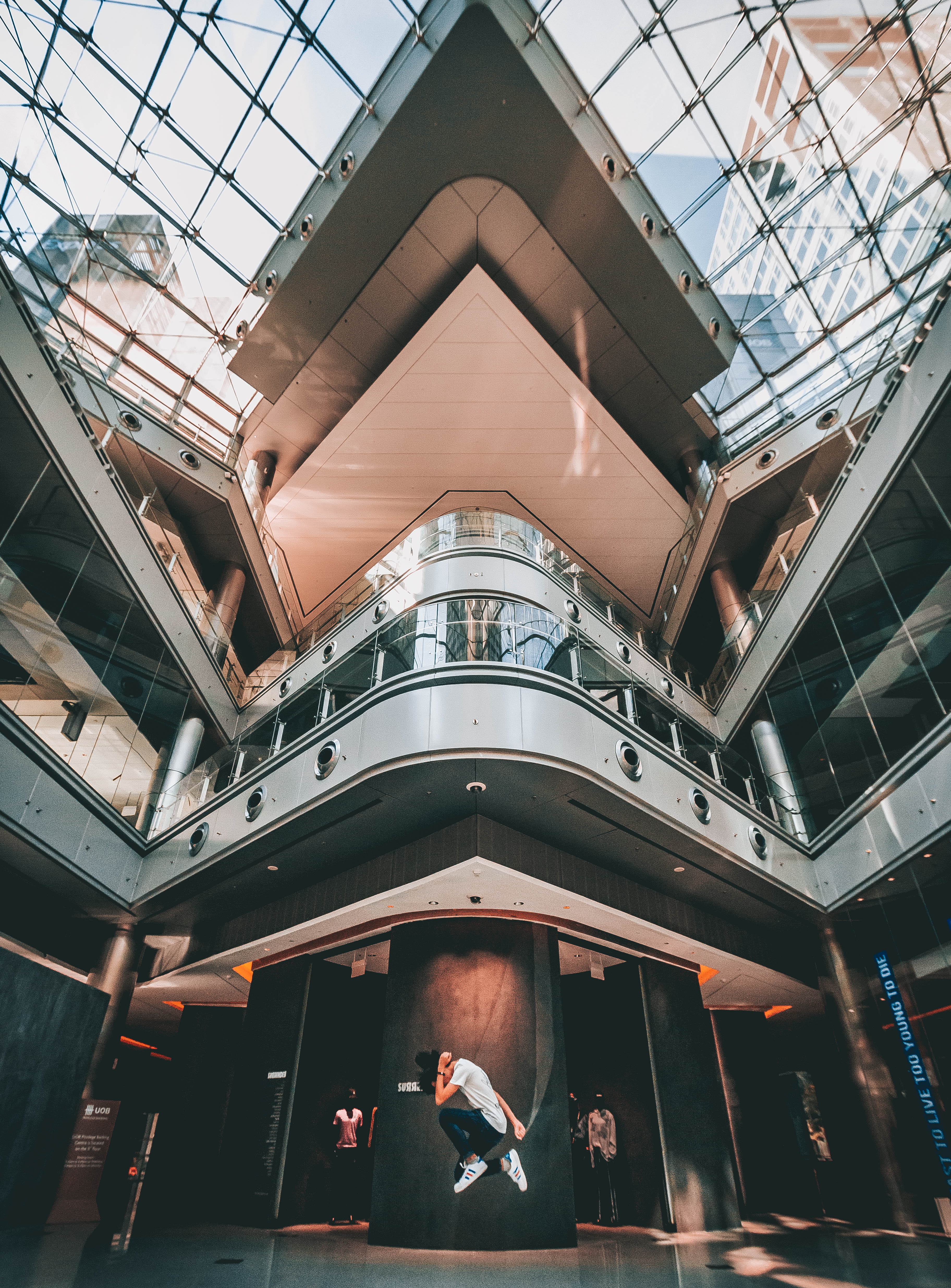 incidental people, portrait, building, city, angle, low angle view, tall, glass, low, built structure, ceiling, jumping, urban, people, leisure activity, Phone HD Wallpaper