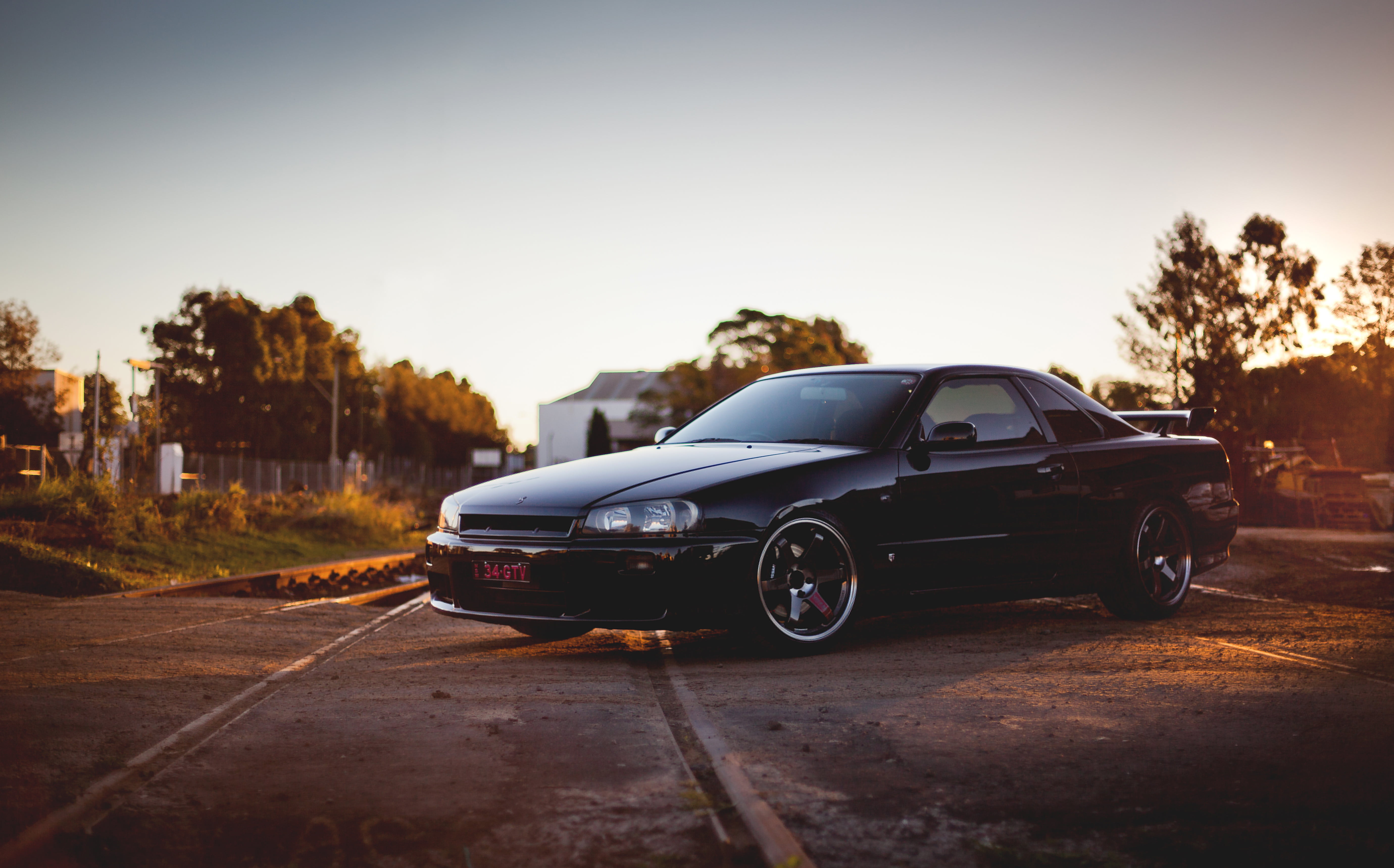 transportation, gtr, day, headlight, color Image, speed, shiny, side View, copy space, railroad, black Color, black, front View, coupe, outdoors, sky, plant, HD Wallpaper
