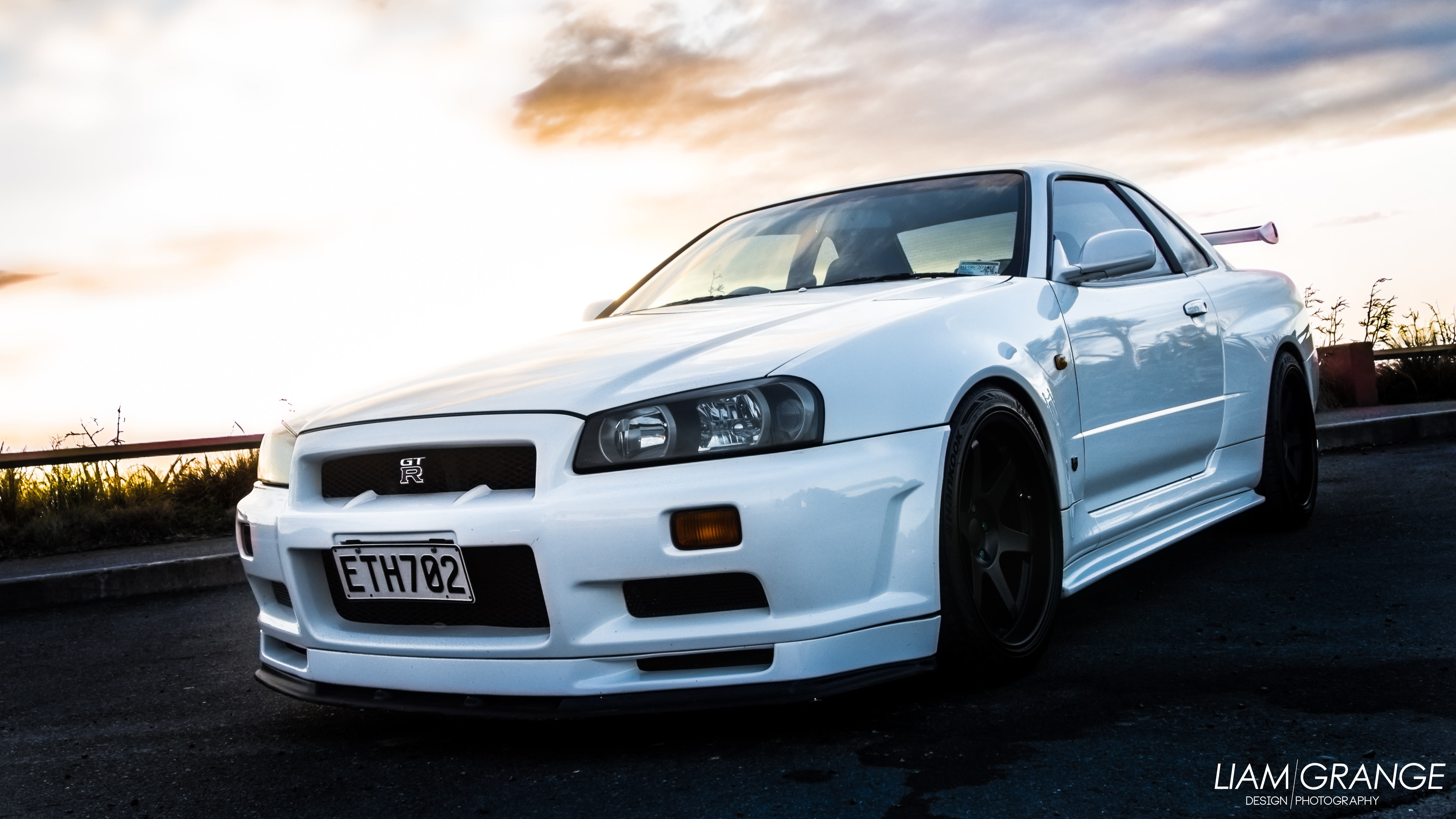 text, road, Nissan Skyline GT-R R34, sky, street, motor vehicle, stationary, no people, 4K, outdoors, architecture, Nissan, cloud - sky, nature, travel, HD Wallpaper