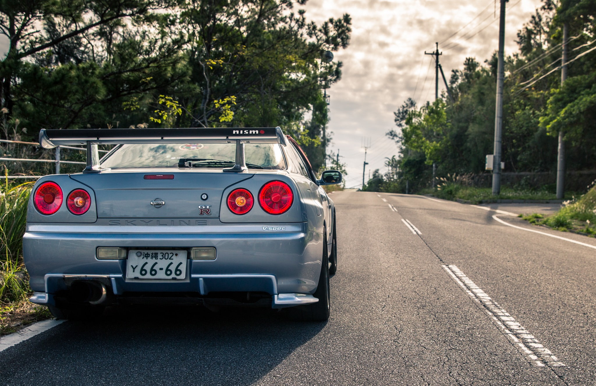 plant, outdoors, Nissan, nature, day, mode of transportation, symbol, city, road marking, 1080P, road, car, Nissan Skyline GT-R R34, JDM, motor vehicle, HD Wallpaper