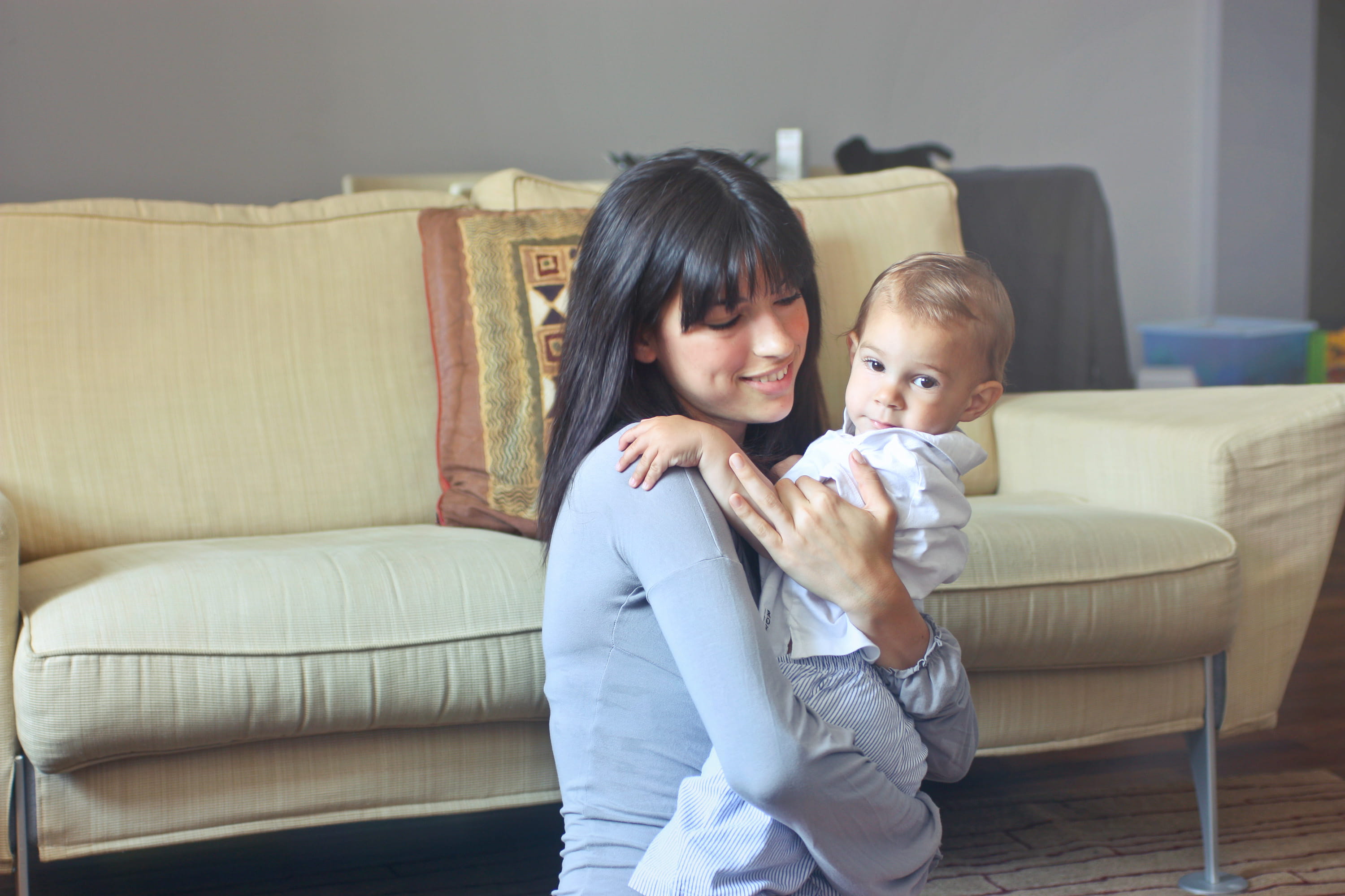 love, sitting, beige sofa, affection, indoor, living room, Carrying, Young, window, emotion, house, woman, beige, black hair, furniture, gray top, family with one child, HD Wallpaper
