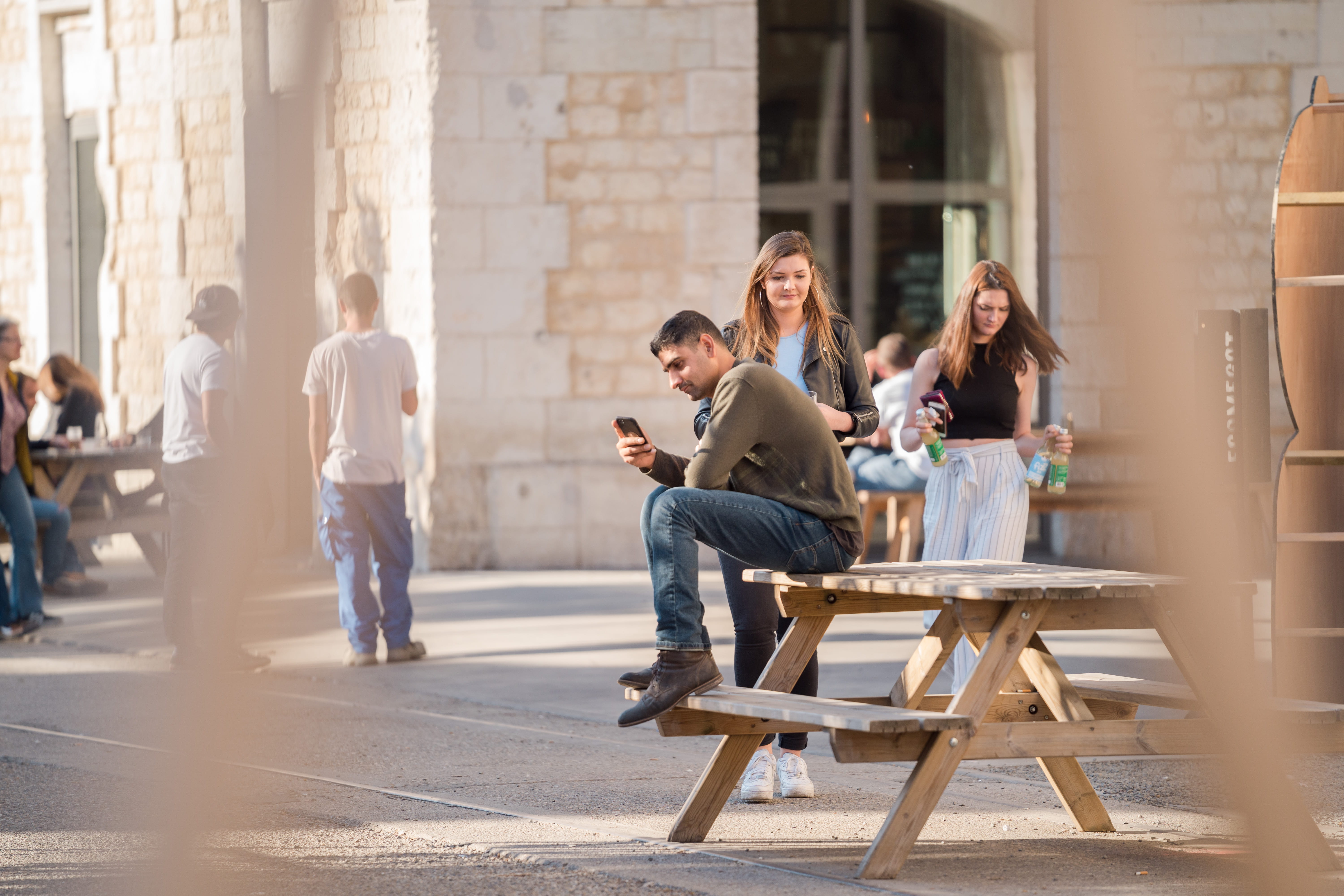 casual clothing, technology, group of people, sits, group, architecture, travel, portable information device, young adult, near, jeans, seat, friends, sleeved, HD Wallpaper