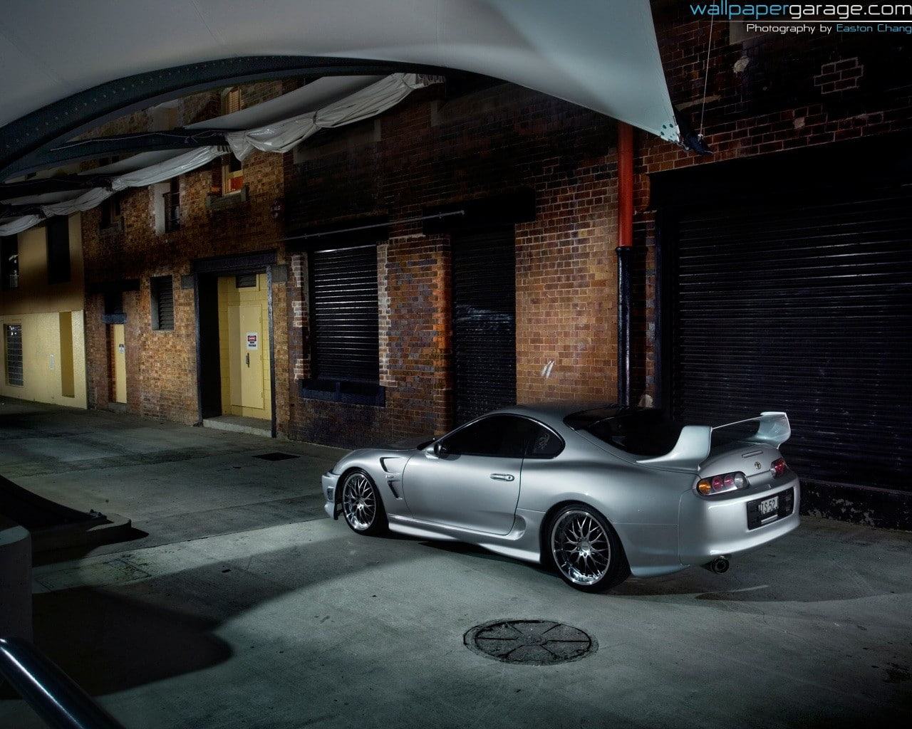 motor vehicle, stationary, day, Toyota Supra, brick, architecture, 720P, building, land vehicle, indoors, transportation, luxury, mode of transportation, HD Wallpaper