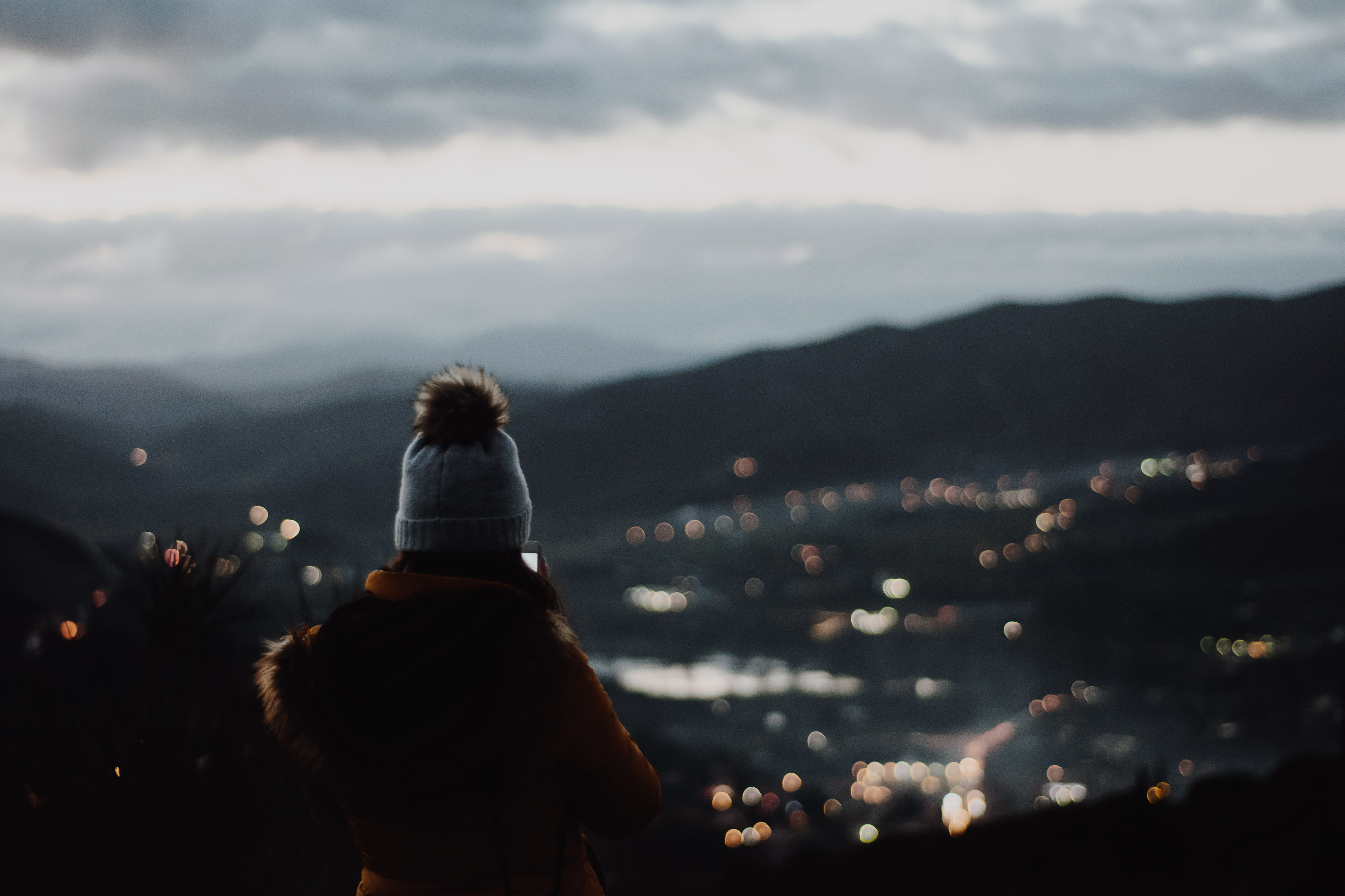 cliff, wearing, rear view, bobble, sky, standing, contemplation, view, cloud - sky, 5K, one person, women, lifestyles, beanie, illuminated, nature, beauty in nature, HD Wallpaper