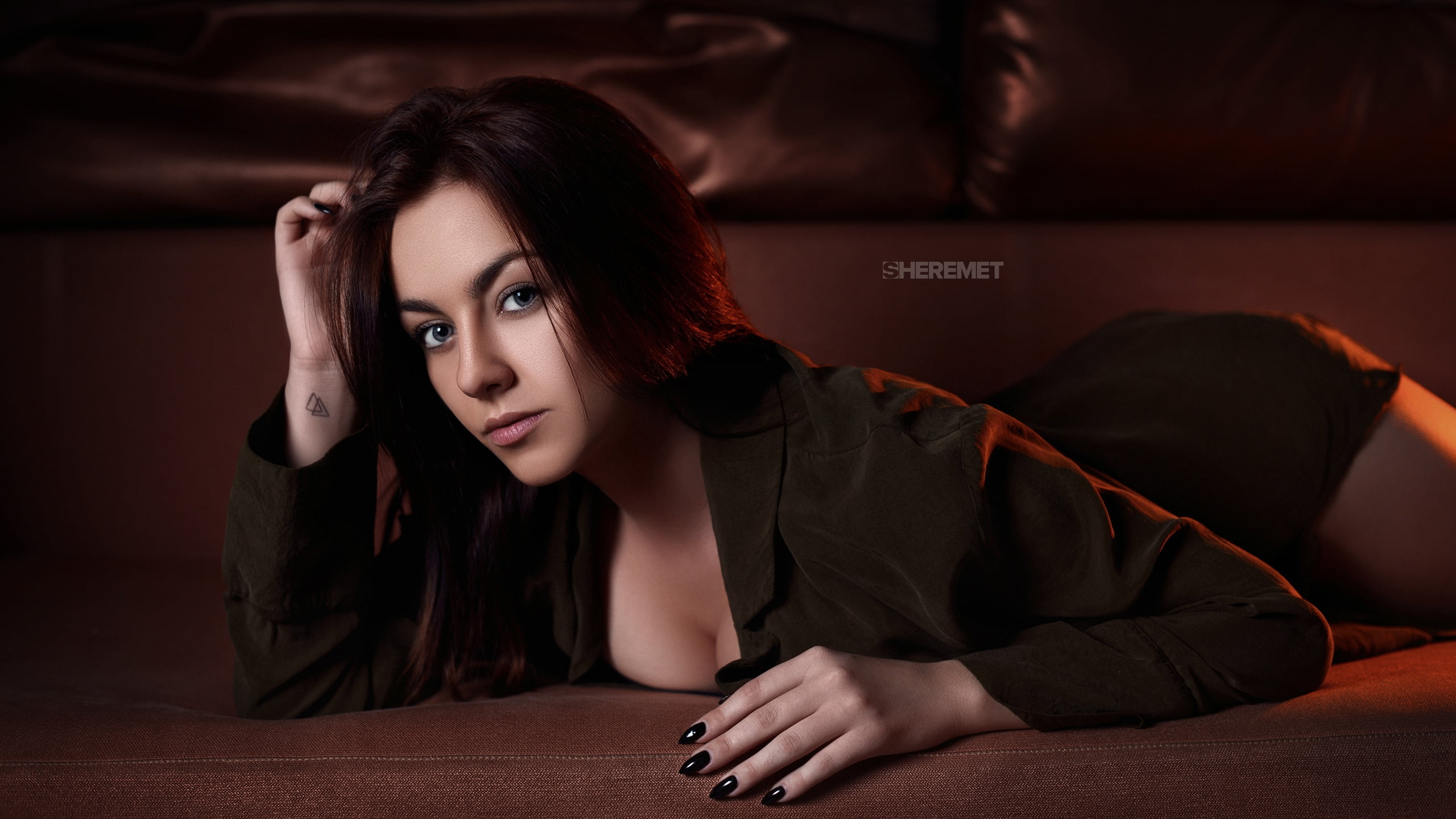 black nails, looking at viewer, couch, long hair, depth of field, shirt, women, lying on front, brunette, gray eyes, touching hair, indoors, painted nails, HD Wallpaper