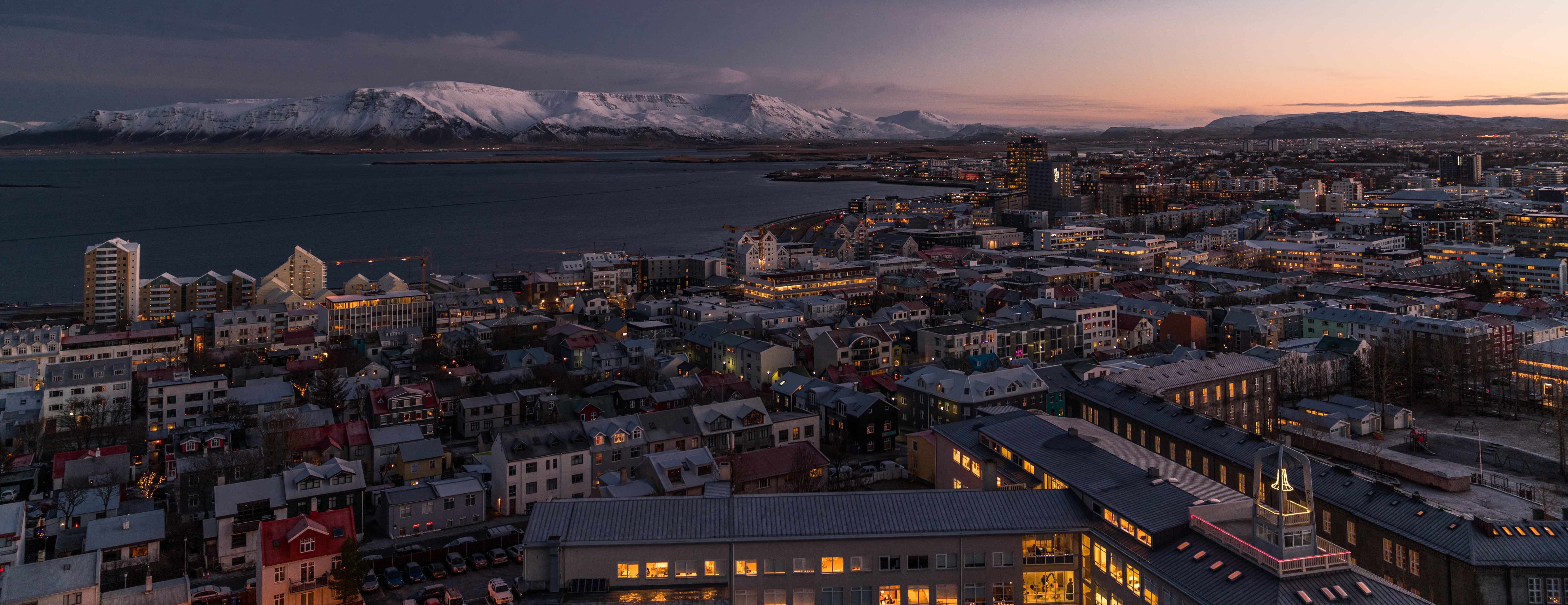 building, built structure, 5K, sea, illuminated, snow, skyscraper, high angle view, multiple display, sunset, cloud - sky, city, mountains, water, night, HD Wallpaper
