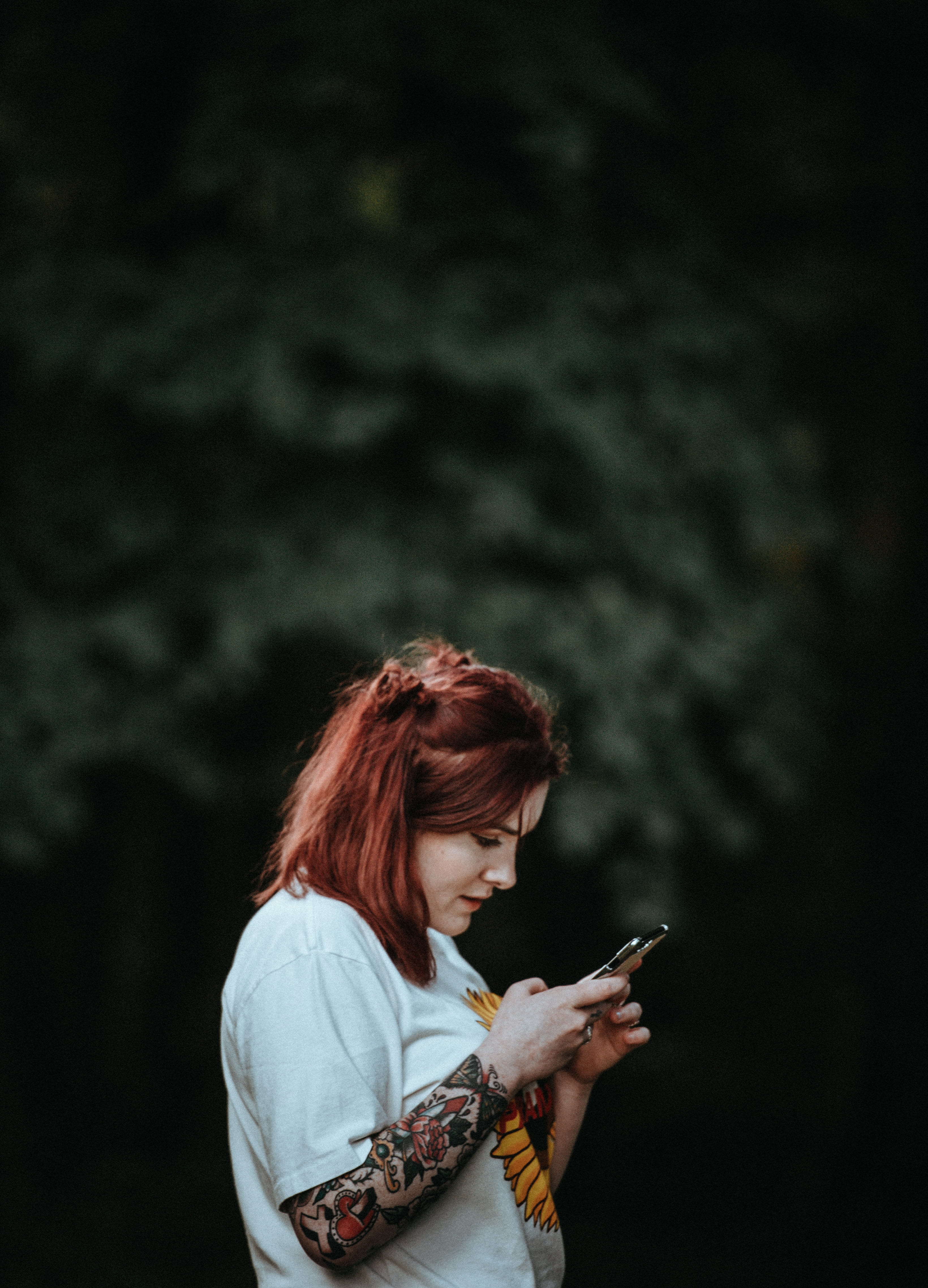 photography, hairstyle, hair, one person, looking, ginger, woman, three quarter length, tattooed woman, selective, holding, using, side view, dark, mood, Phone HD Wallpaper