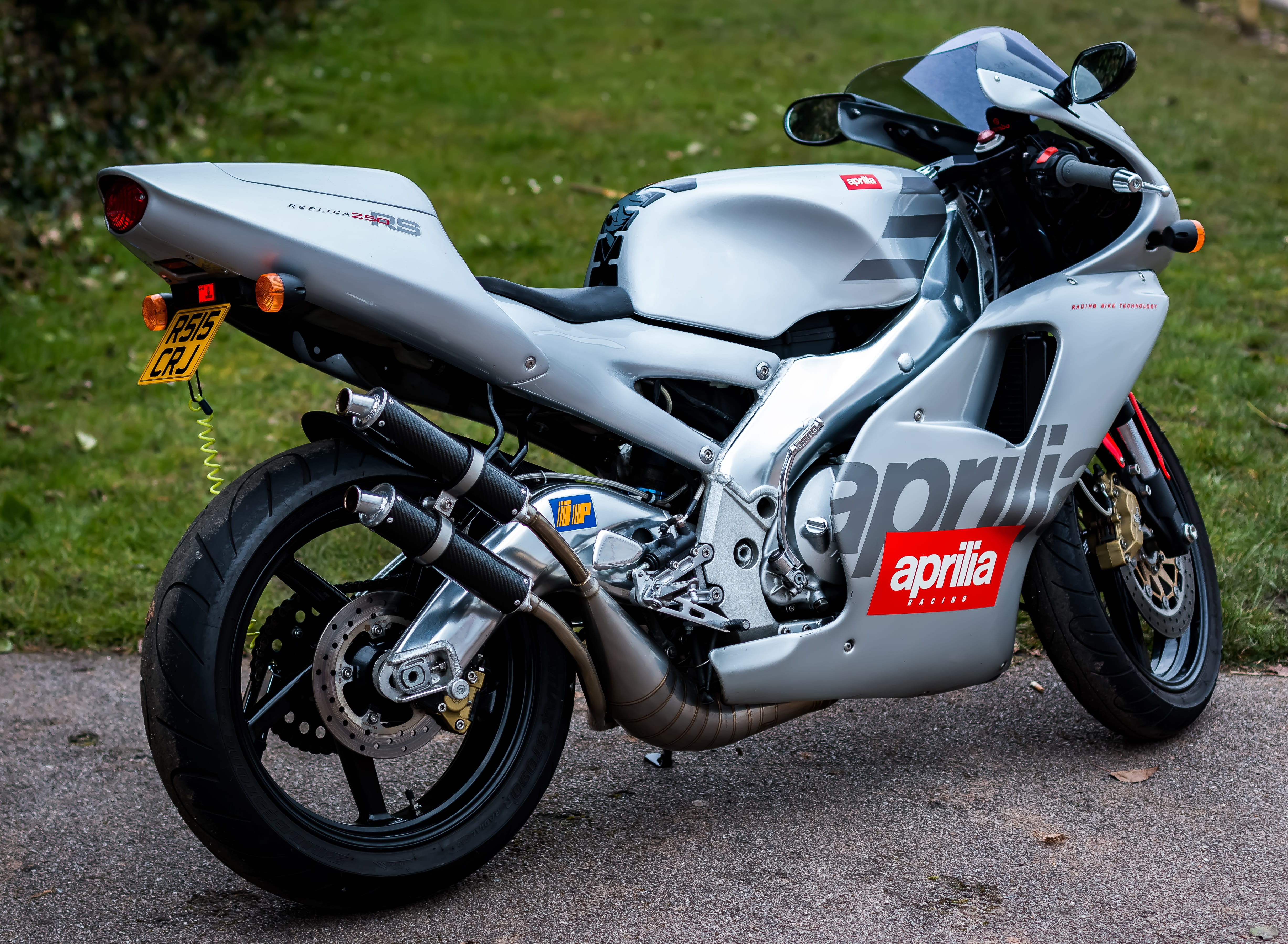 outdoors, bike, silver colored, bicycle, side view, transportation, helmet, parking, speed, street, aprilia rs250, stationary, mode of transportation, day, HD Wallpaper