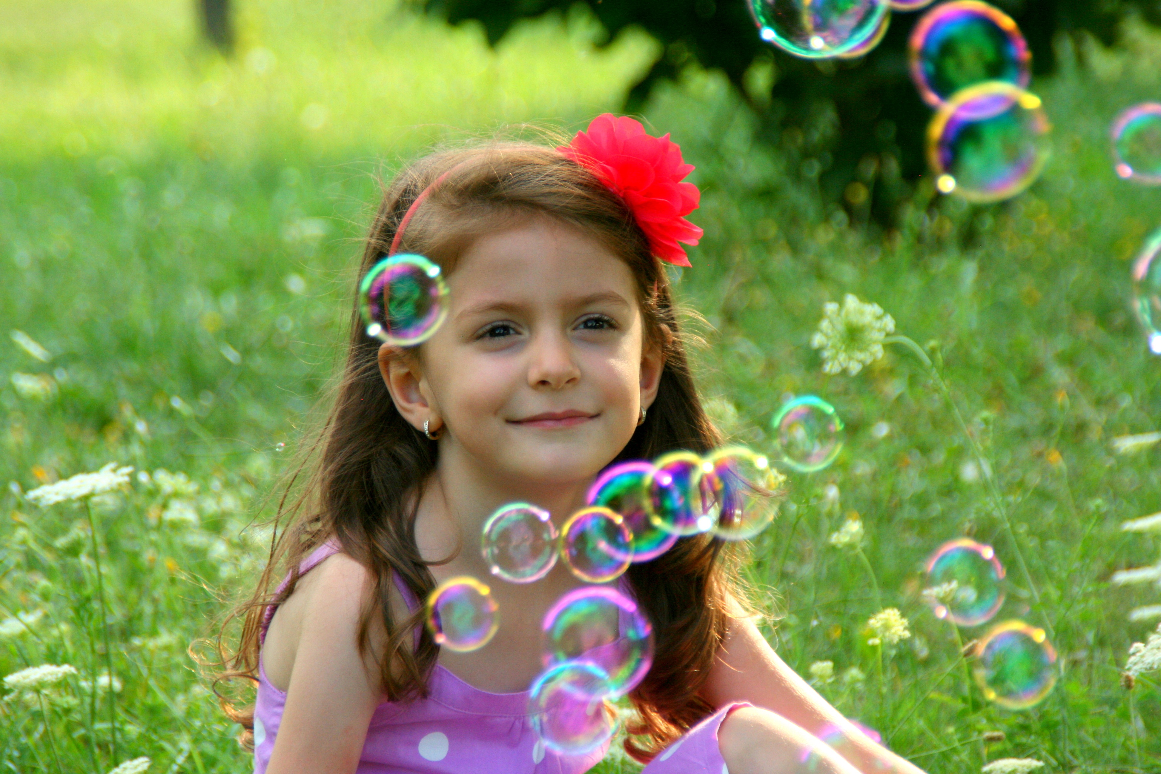 looking at camera, day, focus, bubbles, girl, grass, plant, bubble, real people, portrait, nature, blowing, happiness, sitting, hairstyle, girls, bubble wand, HD Wallpaper
