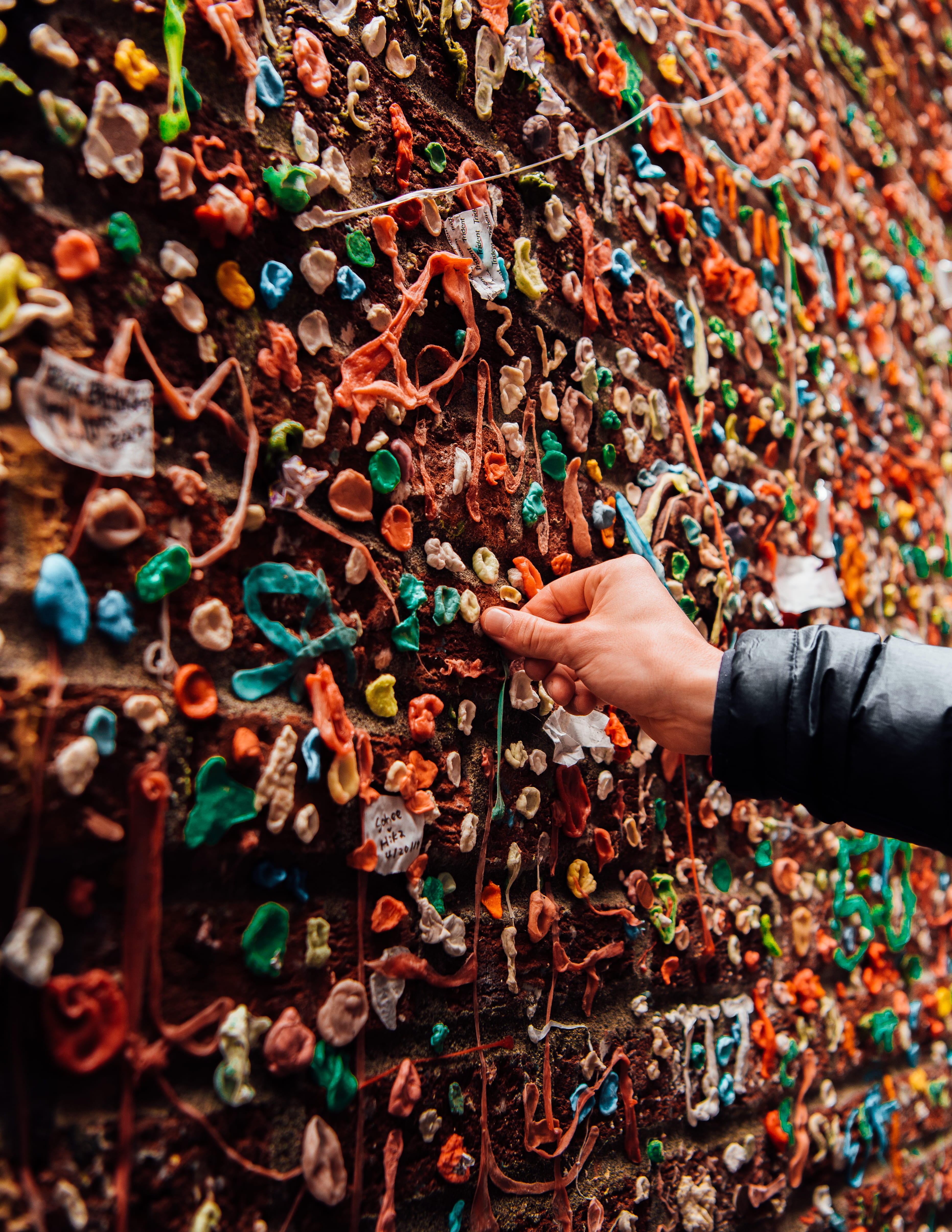 leisure activity, body part, person, holding, decoration, wall - building feature, colourful, real people, brown, multi colored, brick, human finger, assorted, Phone HD Wallpaper