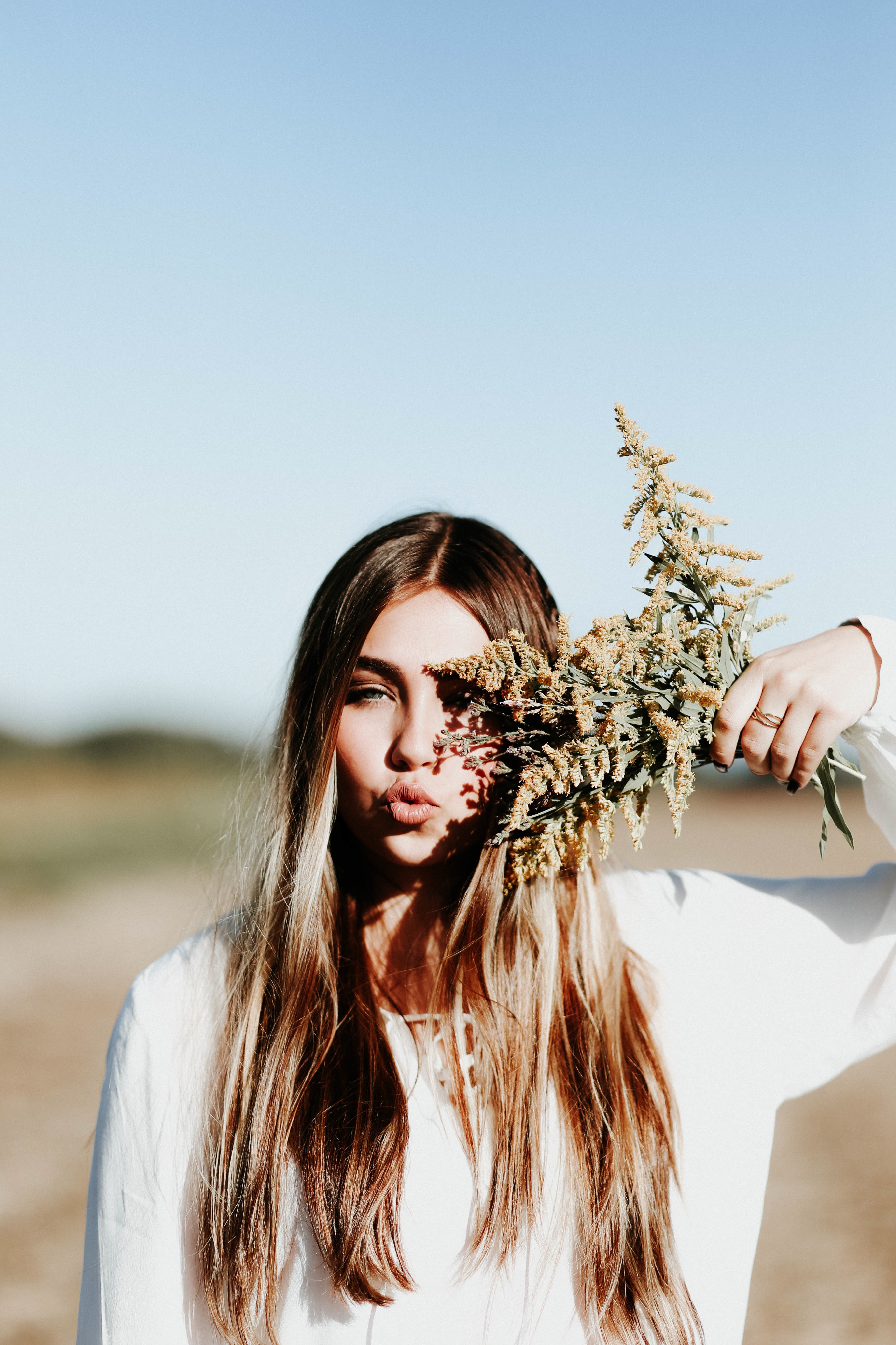 holding, flower, portrait, adult, front view, one young woman only, grass, model, hairstyle, nature, leisure activity, flowering plant, hair, one person, Phone HD Wallpaper