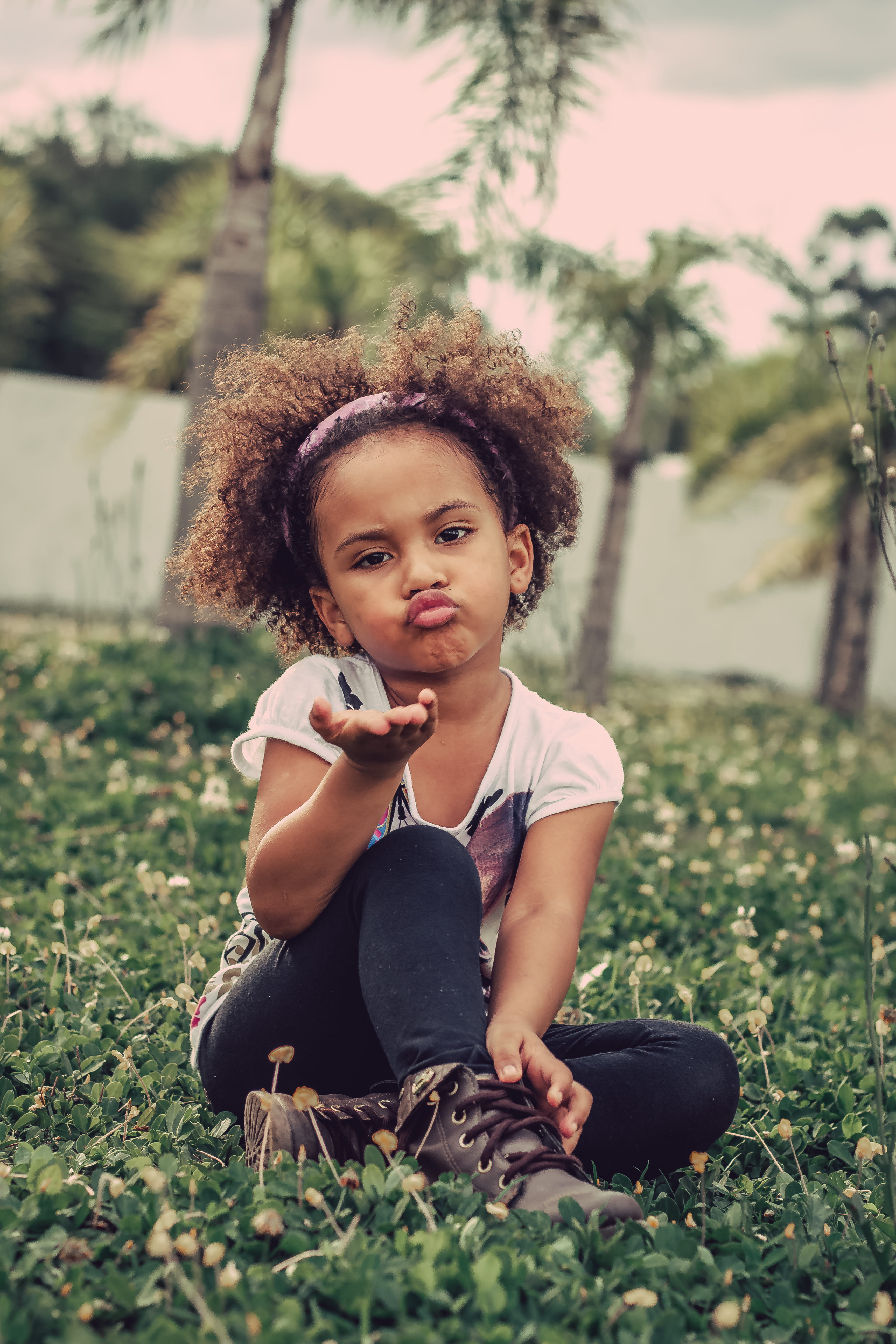 casual clothing, daylight, sitting, facial expression, shallow, females, portrait, childhood, kid, plant, cute, park, day, real people, leisure, girl, curly hair, Phone HD Wallpaper