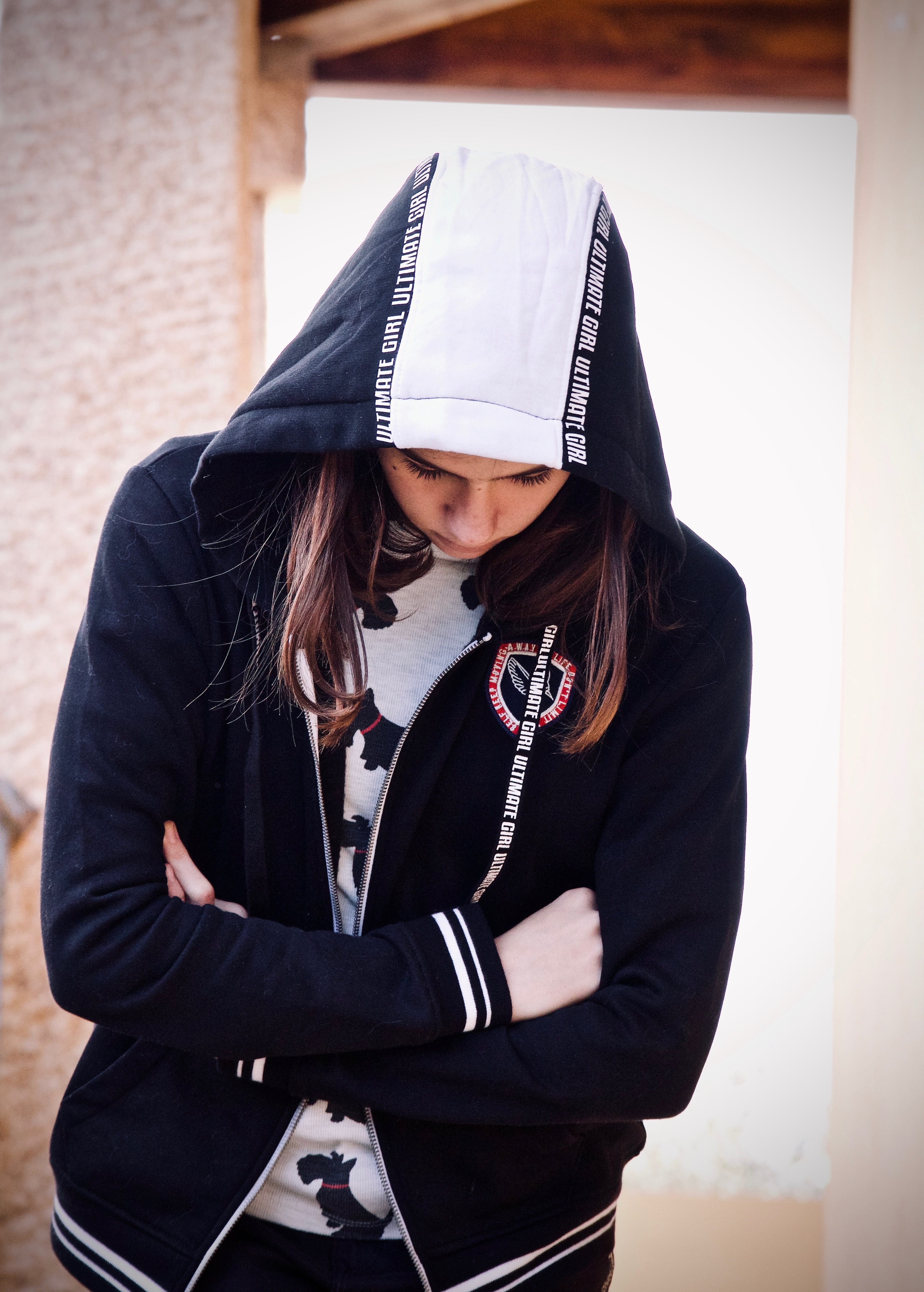 sweatshirt, outdoors, look, wall - building feature, beautiful woman, feeling, hood, focus on foreground, serenity, arms, portrait, sadness, femininity, Phone HD Wallpaper