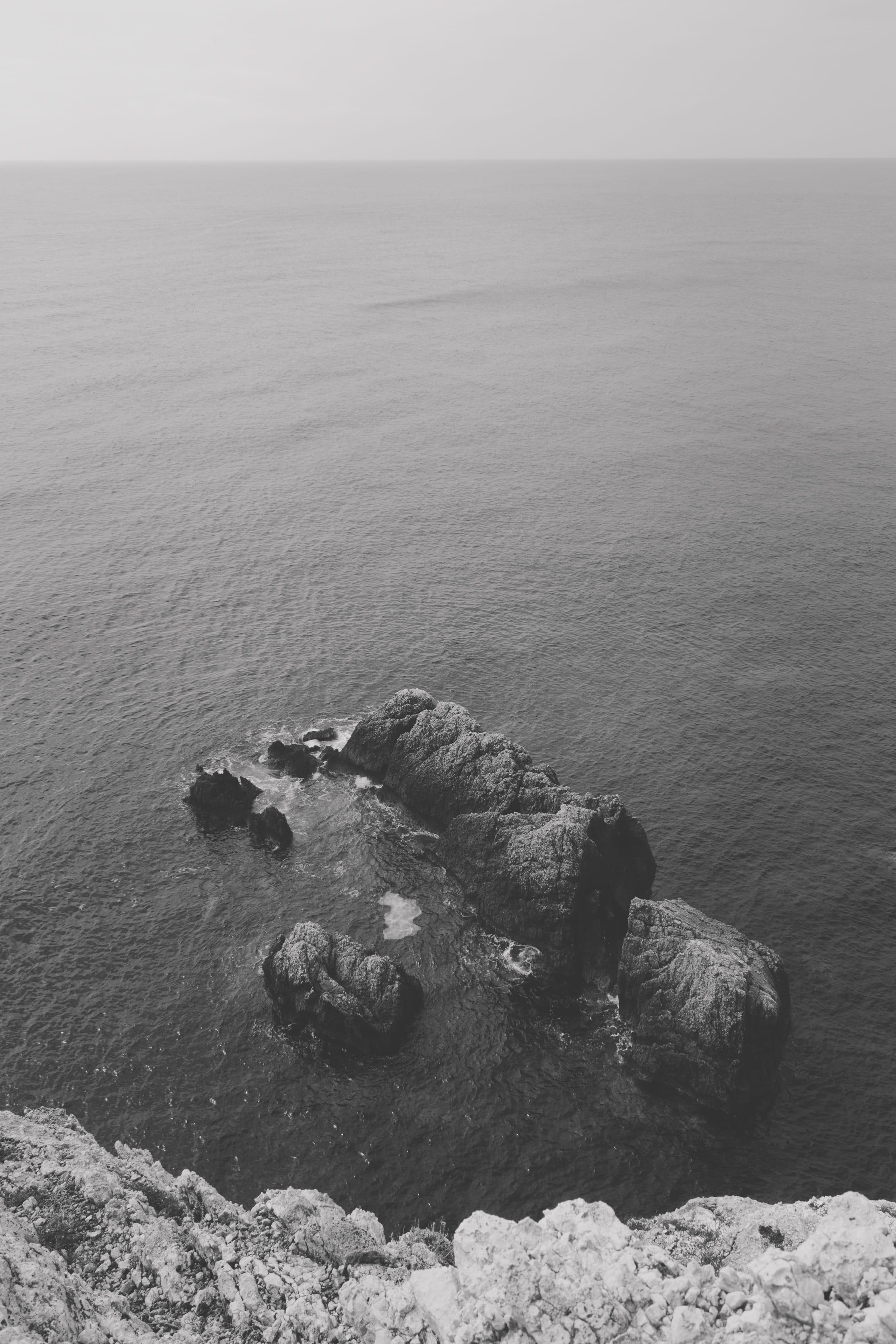 rock - object, nature, outdoors, tranquil scene, day, rocks, cliff, no people, summer, ionian see, august, lefkada, black and white, holiday, monochrome, Phone HD Wallpaper