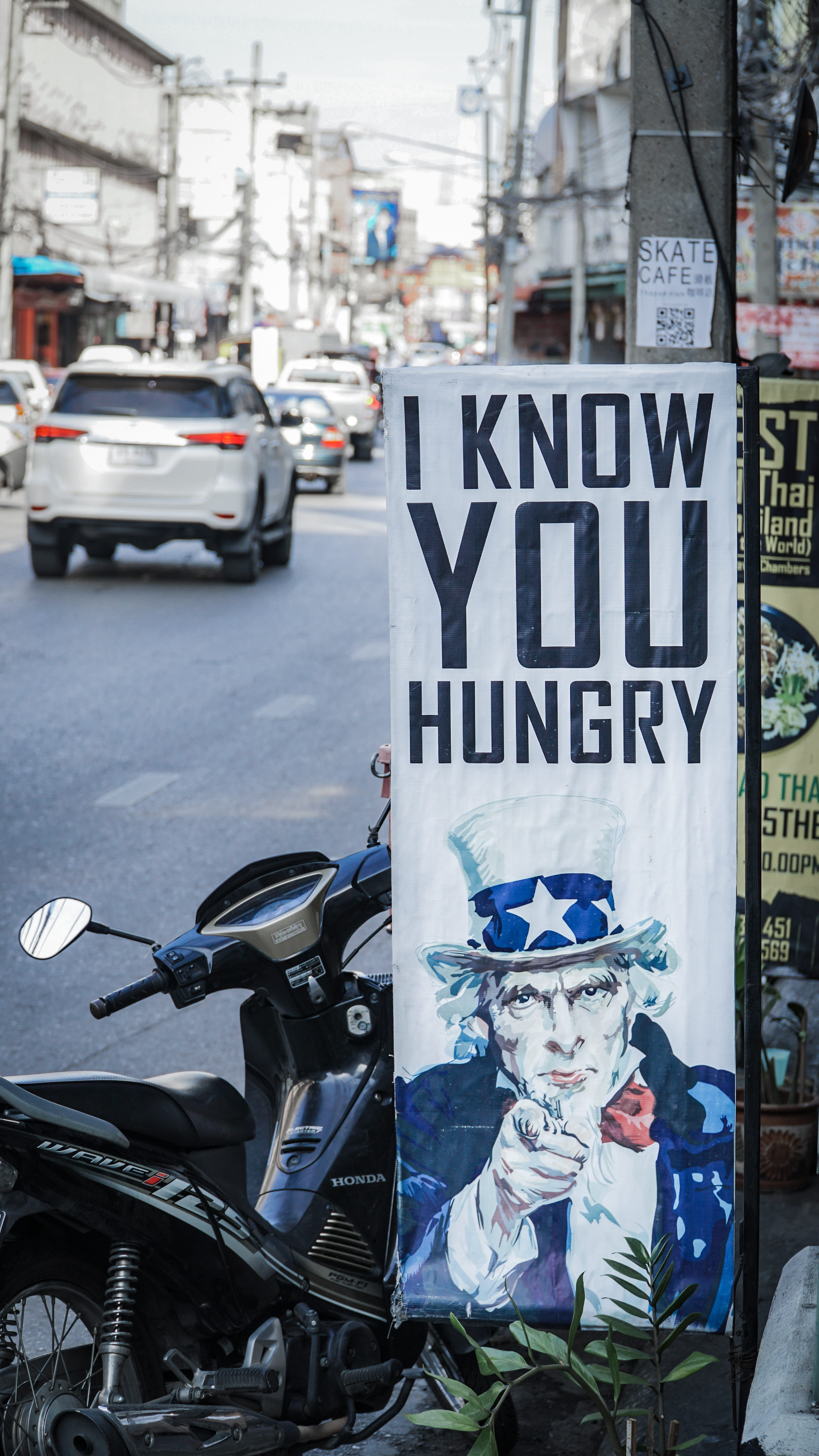 motor vehicle, mode of transportation, uncle sam, alloy wheel, day, sign, motorcycle, people, apparel, machine, transportation, obscured face, wheel, western script, Phone HD Wallpaper