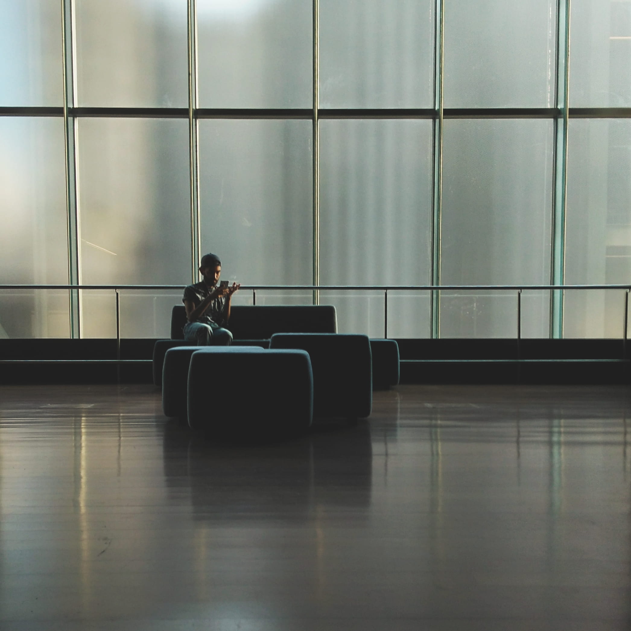 gray, interior design, adult, person, airport, room, wear, black, sitting, 1080P, wireless technology, modern, real people, interior, young, sofa, glass windows, Phone HD Wallpaper