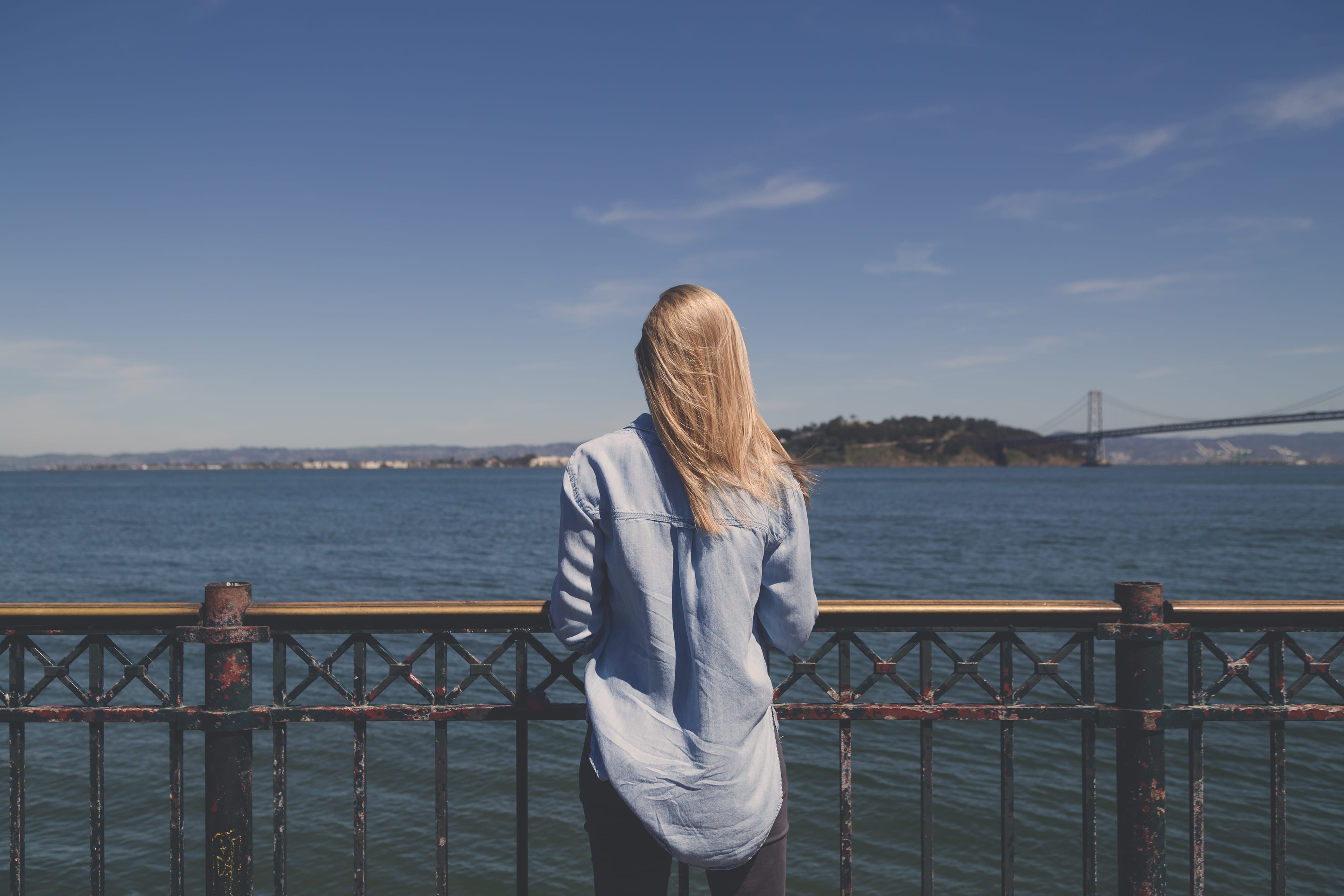 daytime, woman in blue, beauty in nature, long hair, blonde, leisure activity, island, looking at view, metal, body, nature, shirt, seeing, hair, hand rail, HD Wallpaper