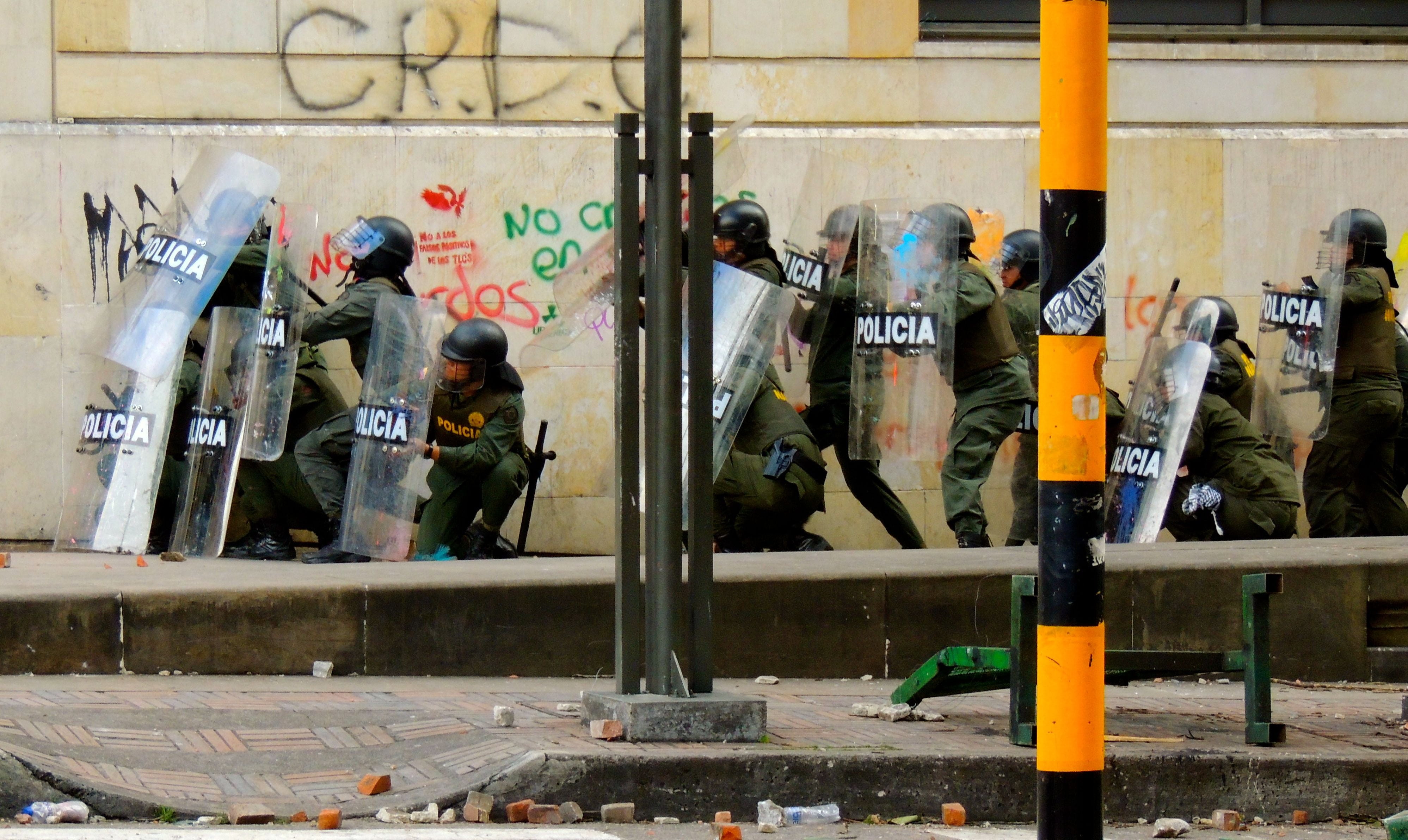 city, pavement, helmet, weapon, near, art and craft, built structure, conflict, building exterior, outdoors, bogota, script, police, text, special forces, HD Wallpaper