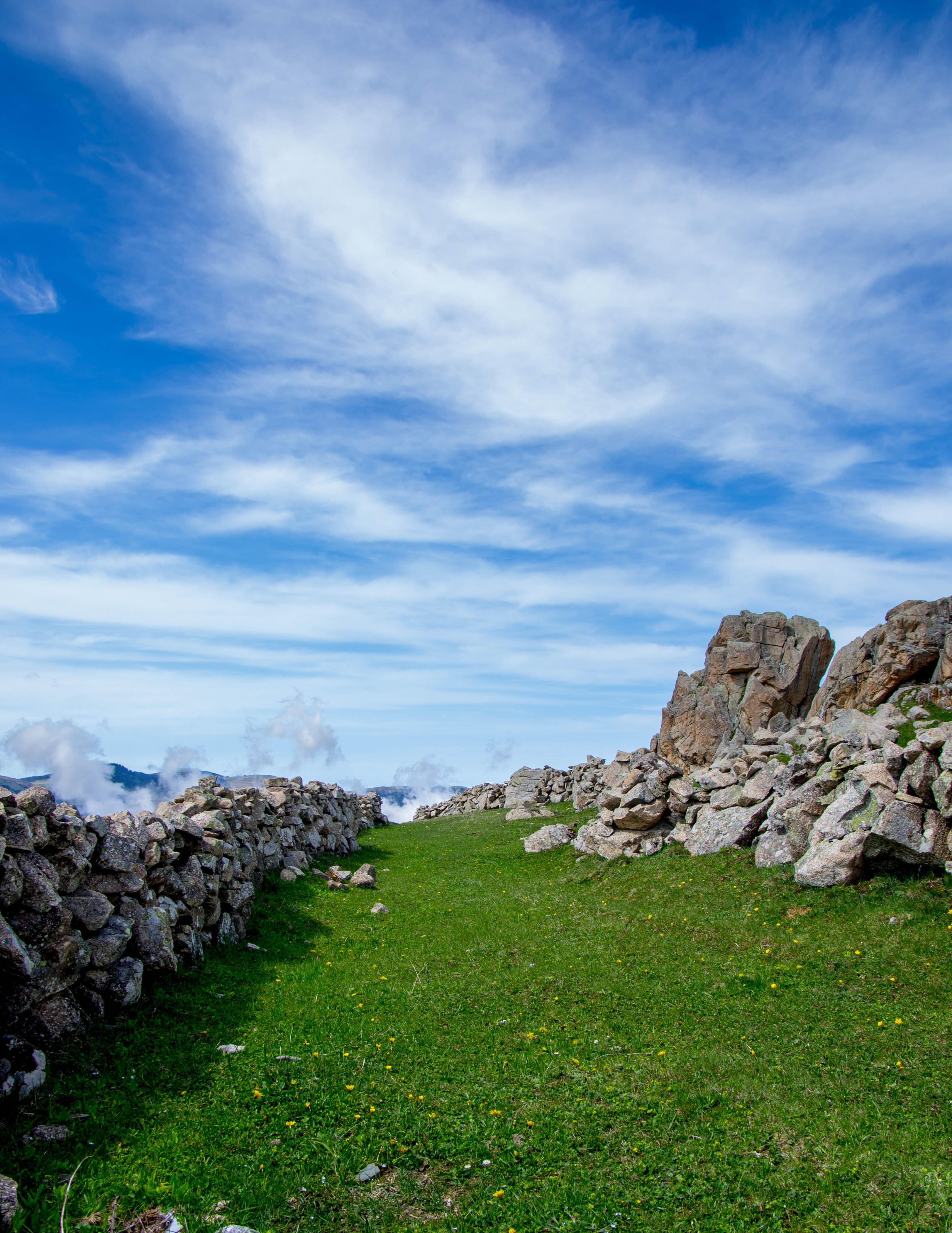 grass, rock - object, green field, plant, mountain, beauty in nature, no people, the stones are, green color, road, solid, green, environment, cloud - sky, Phone HD Wallpaper