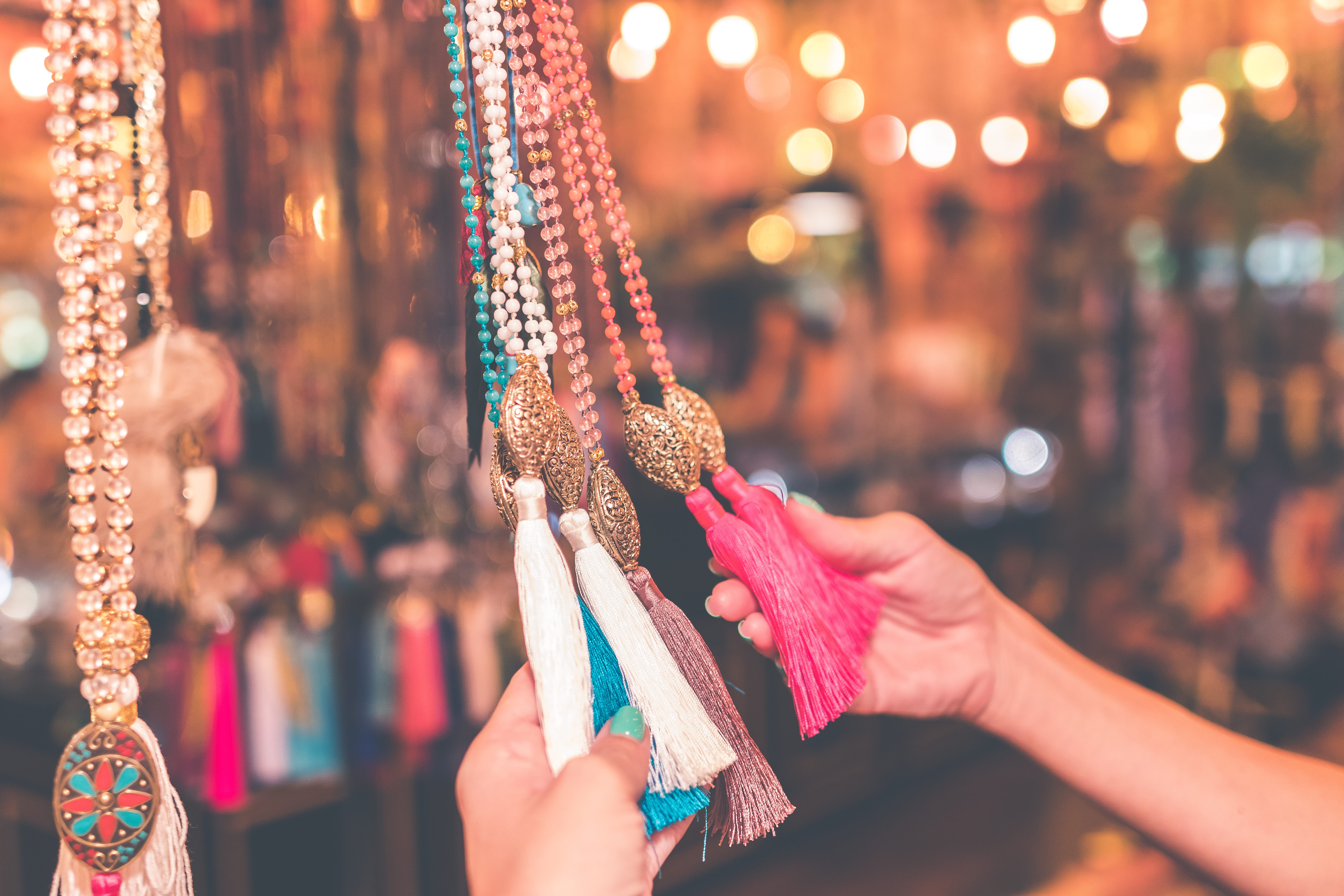 jewellery, close-up, market, focus on foreground, shop, tassel, shopping, business, buying, 5K, retail, bokeh, hand, choice, one person, customer, illuminated, HD Wallpaper