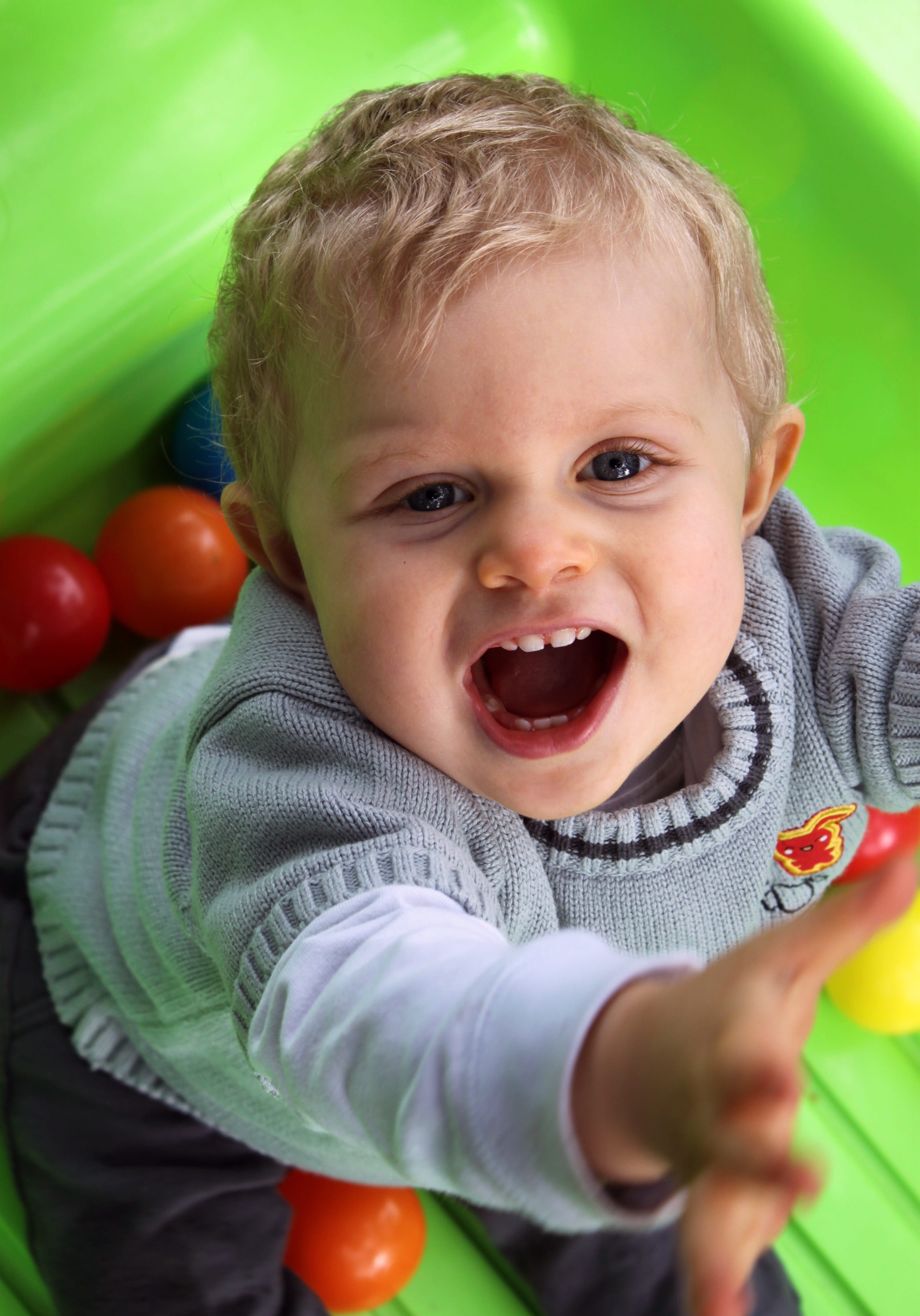 young child, spontaneous, boy, play, baby, mouth, babyhood, looking at camera, innocence, fun activities, petit, waist up, front view, childhood, green, Phone HD Wallpaper