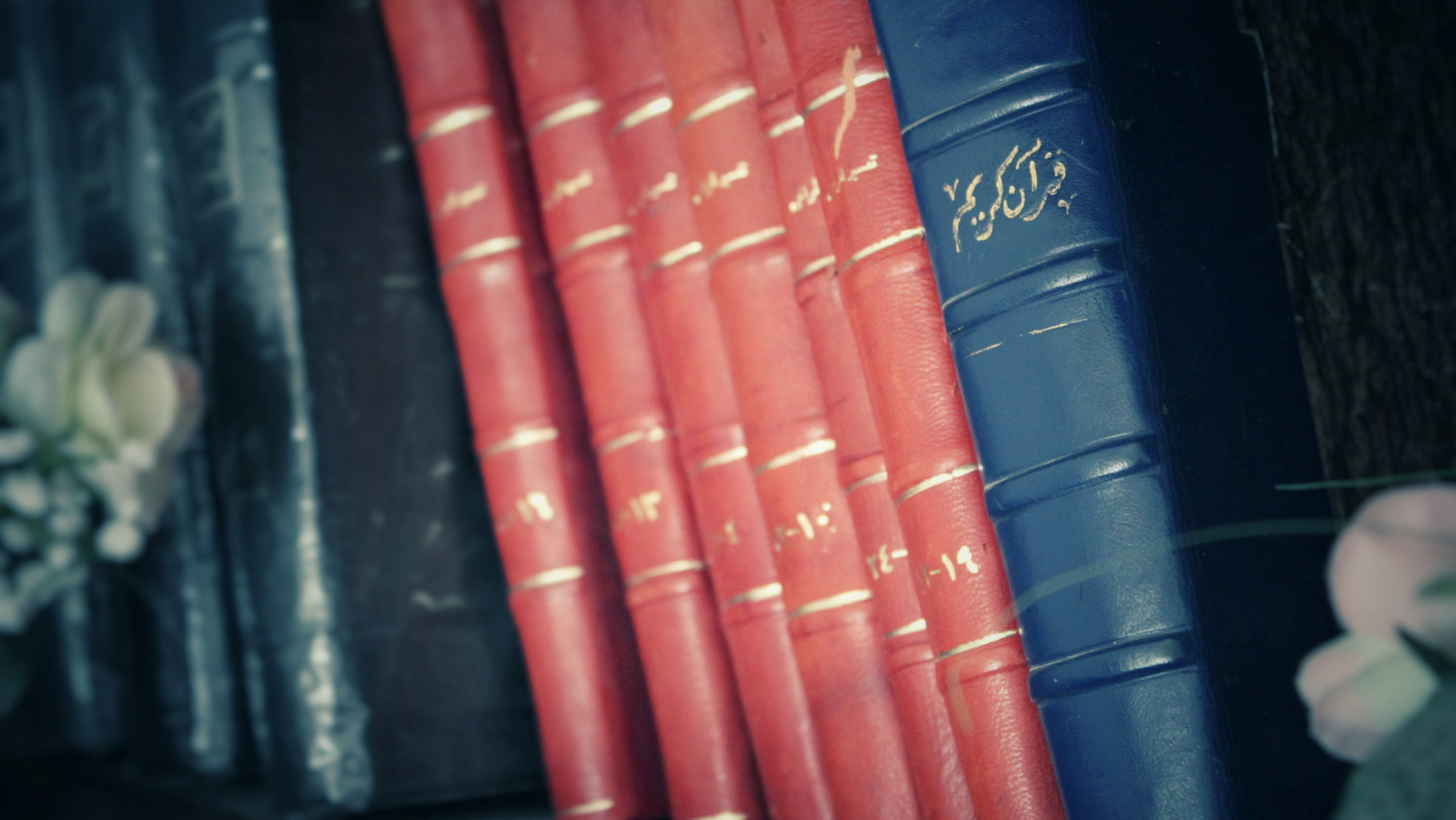 day, 2K, high angle view, quran, indoors, education, selective focus, close-up, books, red, vintage, communication, architecture, still life, focus on foreground, HD Wallpaper