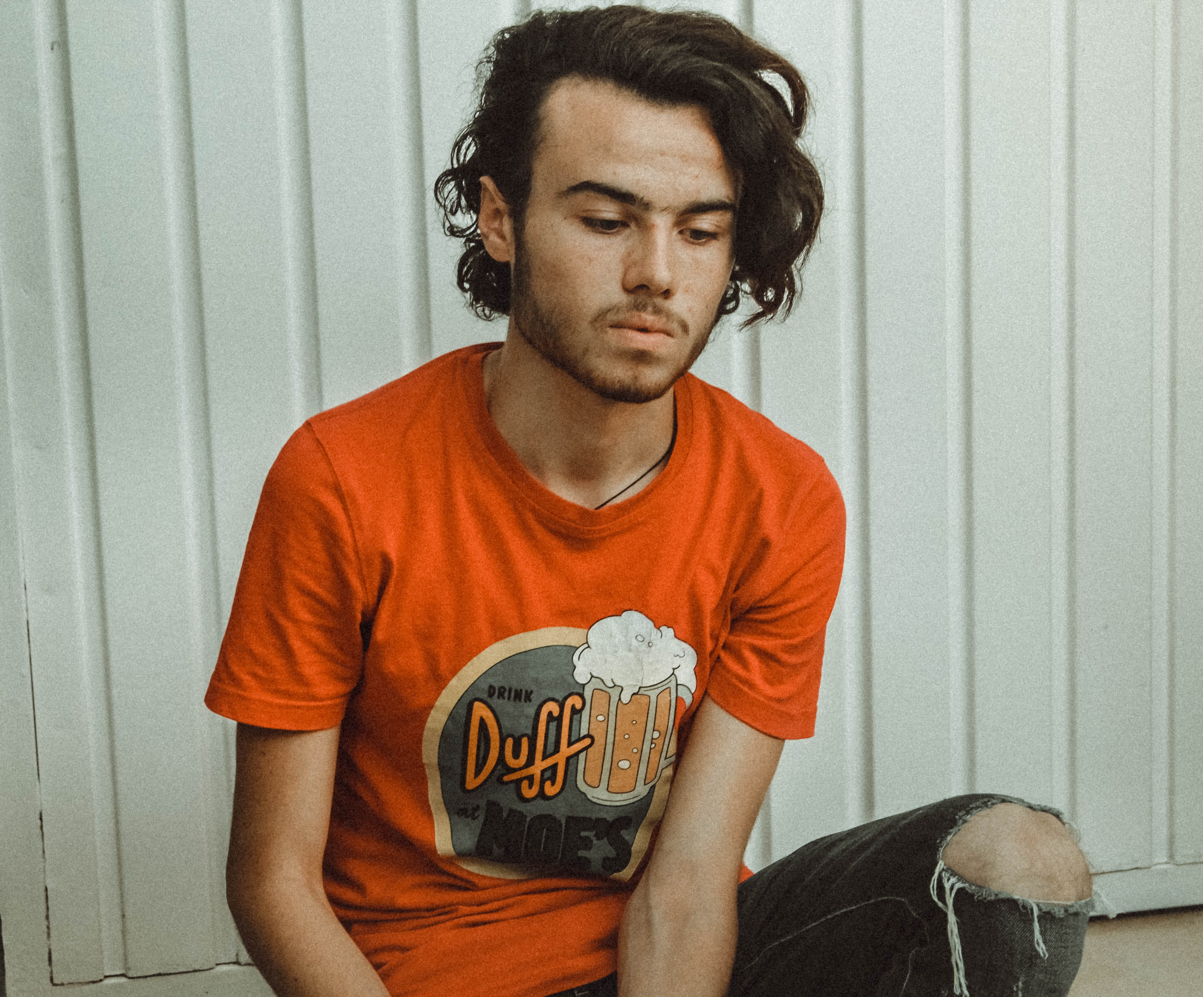 male, communication, real people, white, denim, crew, sitting, orange, holding, neck, three quarter length, simpsons, wall, pose, one person, indoors, t-shirt, HD Wallpaper