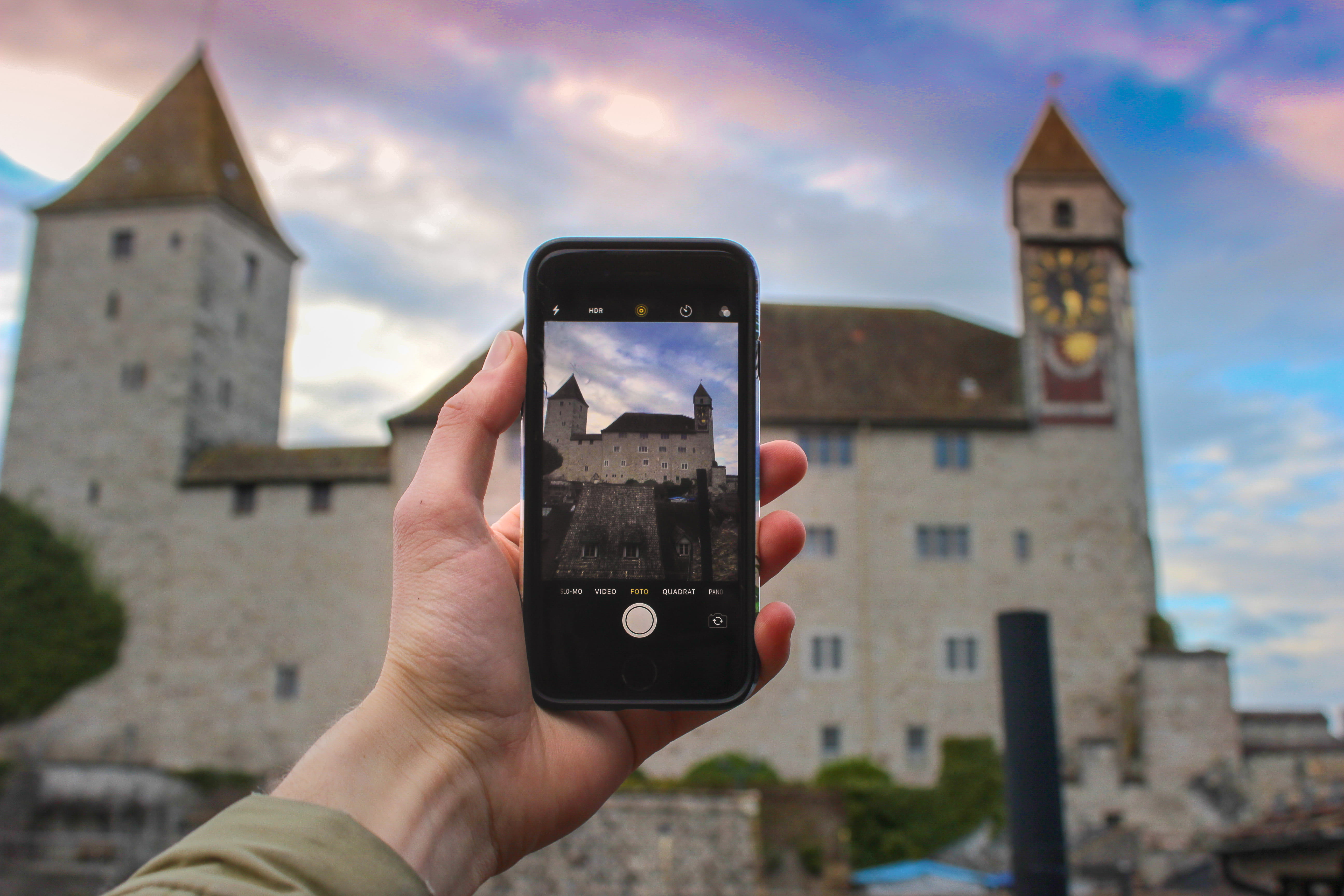 one person, city, castle, built structure, focus on foreground, clouds, outdoors, space, person, urban, sky, technology, human hand, contemporary, iphone, HD Wallpaper