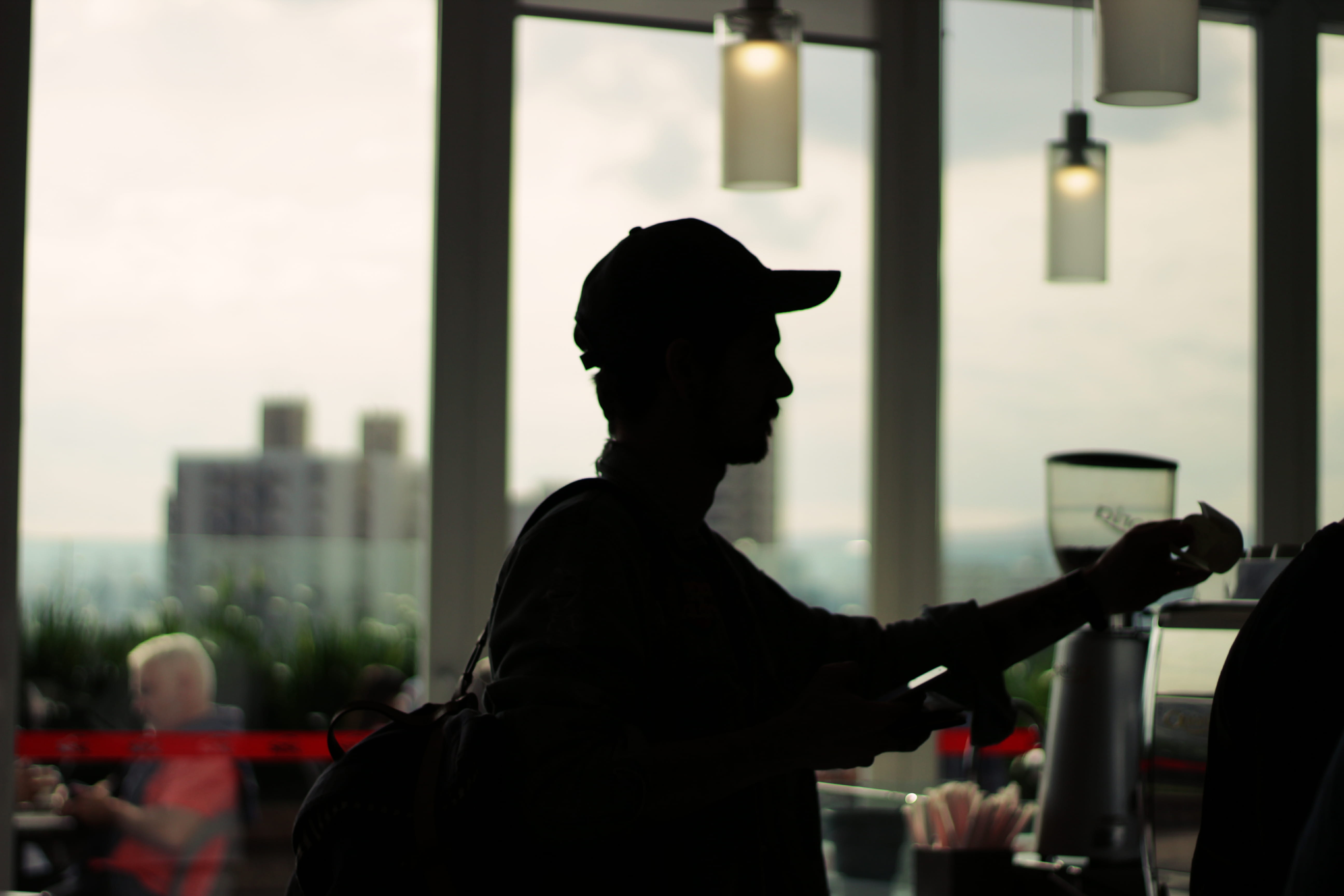 one person, indoors, coffee house, holding, lifestyles, shadow, leisure activity, city, men, focus on foreground, 5K, silhouette, cap, architecture, coffee shop, HD Wallpaper