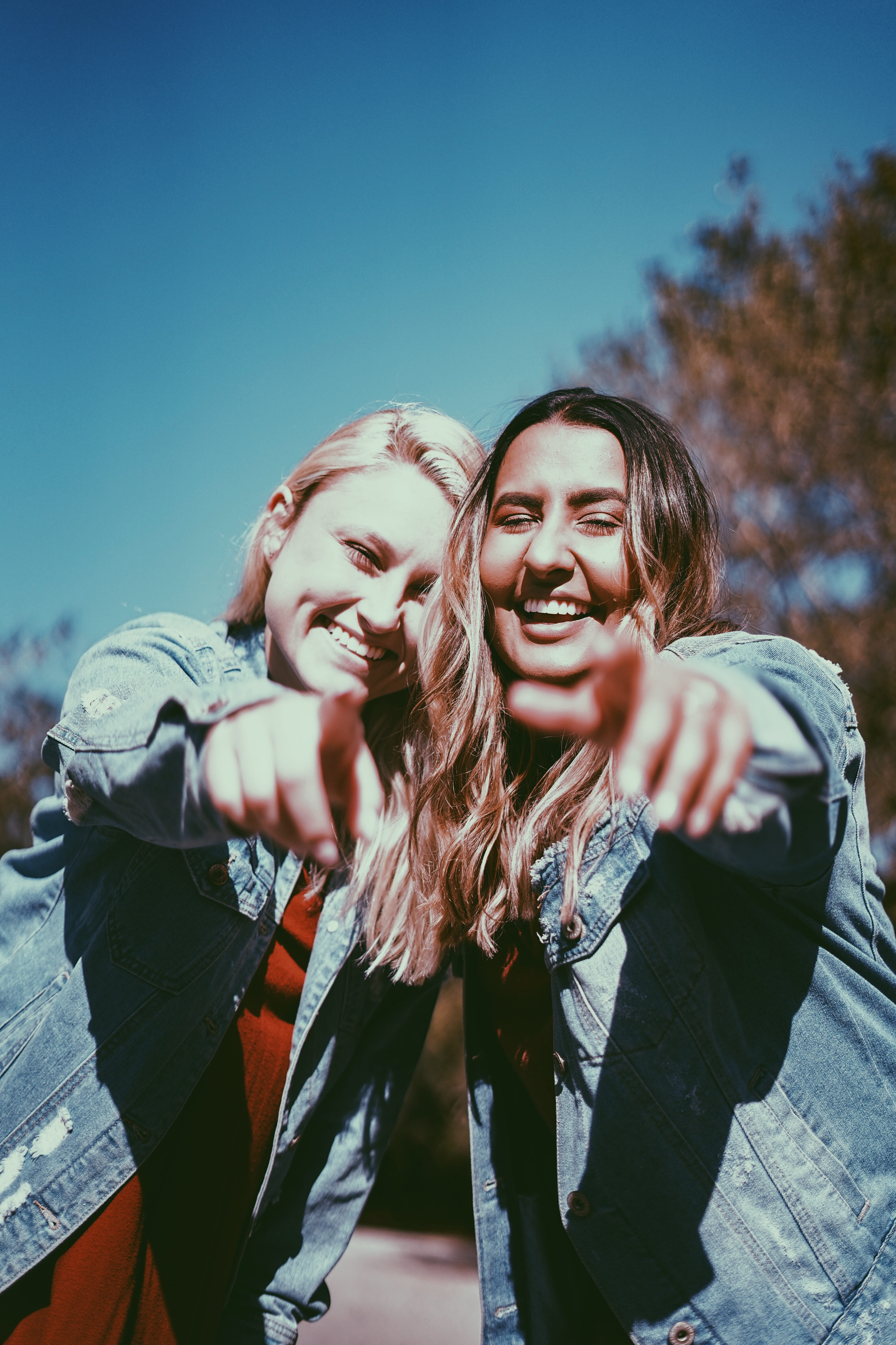 two, smiling, enjoyment, young women, pointing, friendship, front view, hairstyle, young adult, lifestyles, blue, emotion, fingers, hair, bonding, sky, Phone HD Wallpaper